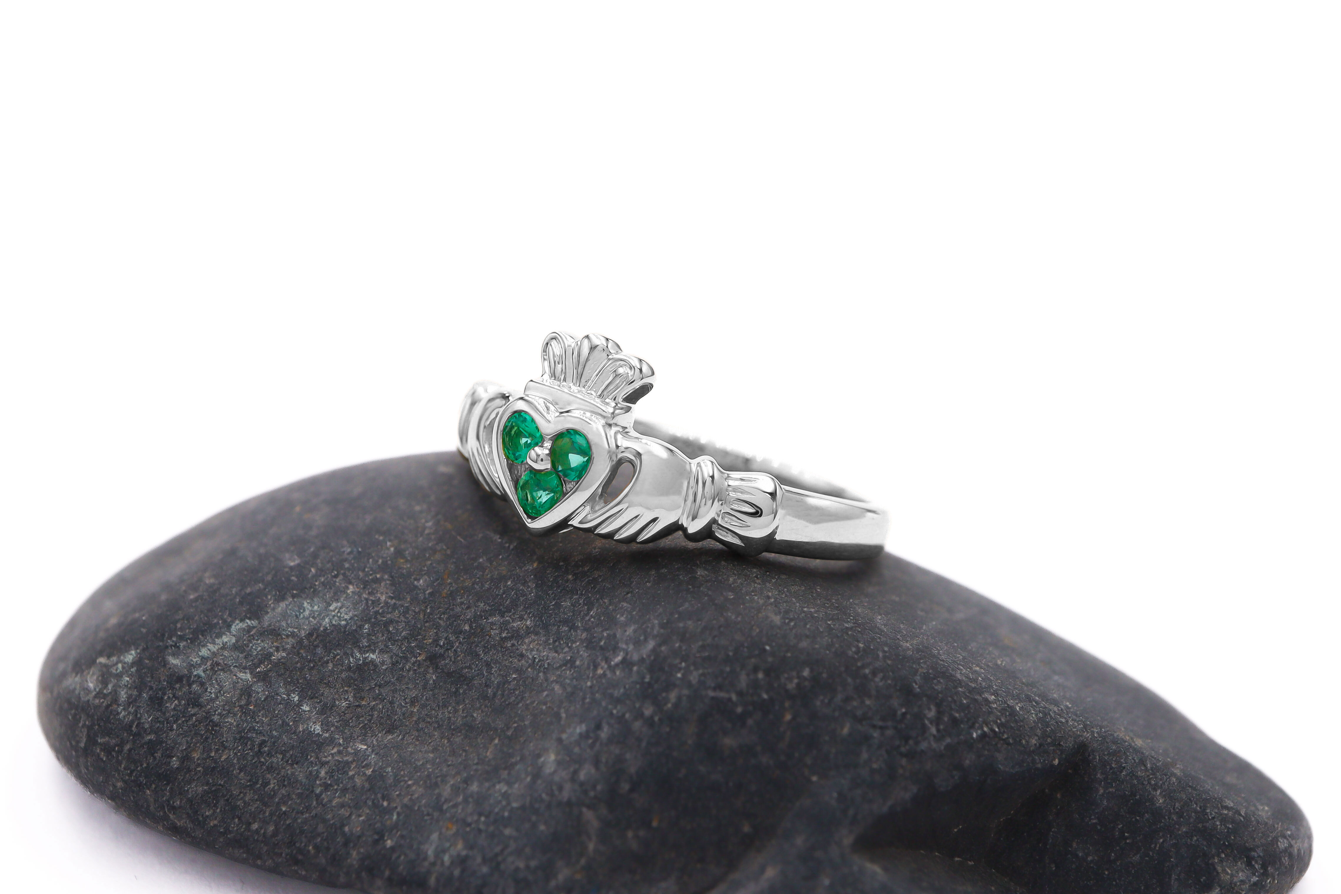14 K white Gold Claddagh Ring Set with 3 Emeralds Sku 9826 on rock