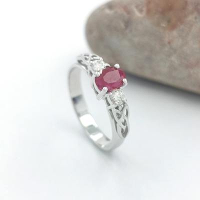 14K White Gold Trinity Knot Ring With 1/2 Carat Oval Ruby