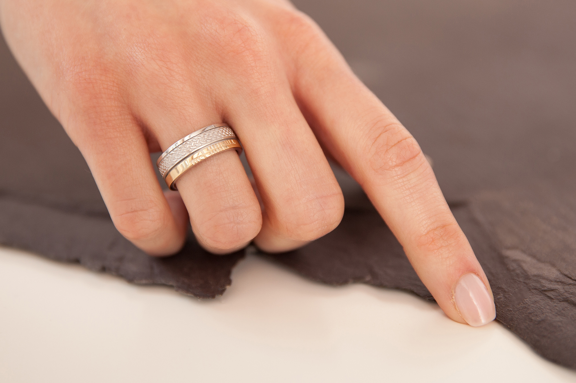 Ogham & Celtic Knot Wedding Ring in Sterling Silver & 10K Yellow Gold With a Florentine Finish - Model Photo