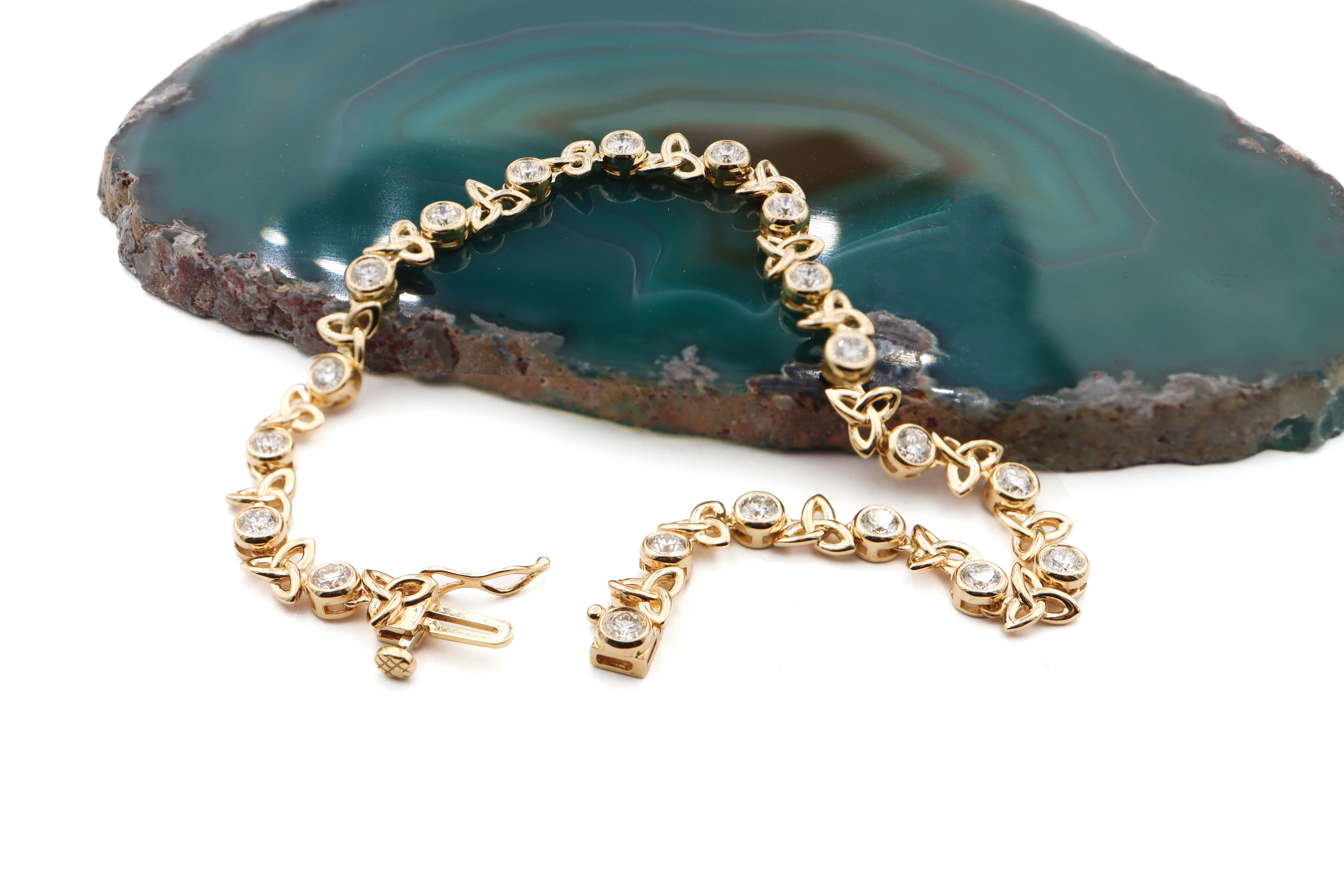 Attractive Yellow Gold Trinity Knot Bracelet With a Polished Finish For Women