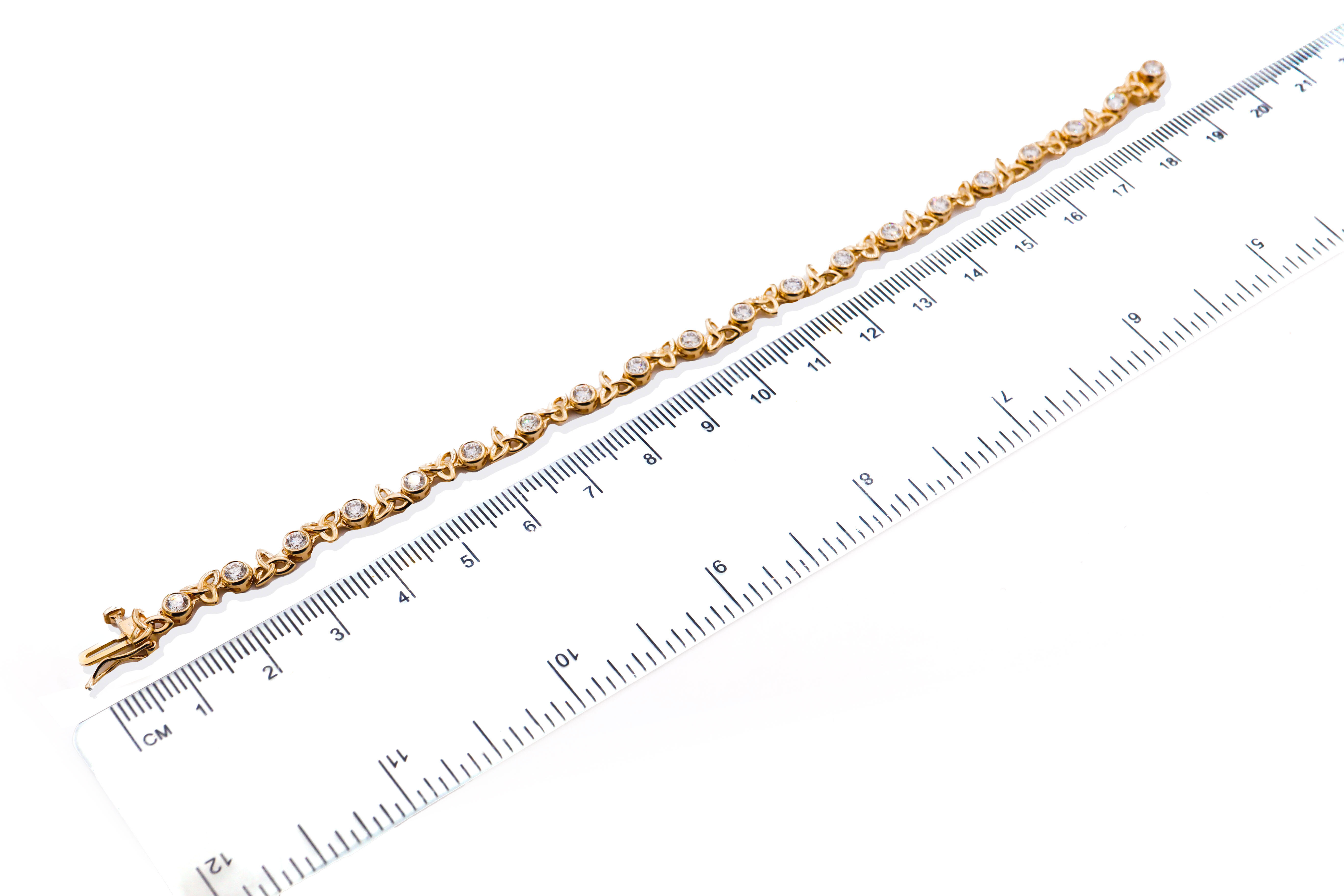 Womens Polished Yellow Gold Trinity Knot Bracelet. Picture For Scale.