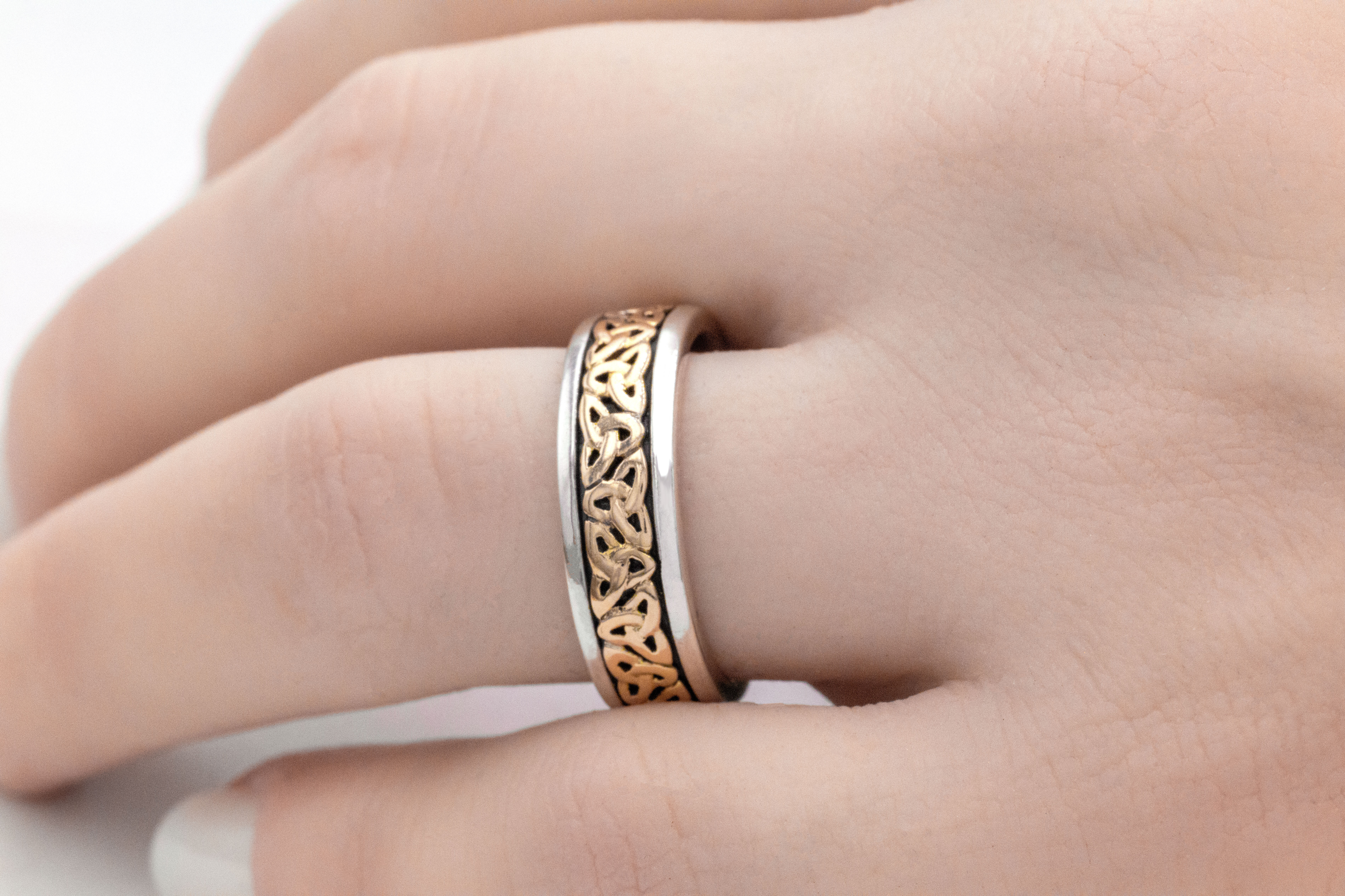 Attractive Sterling Silver & 10K Yellow Gold Celtic Knot & Trinity Knot 6.0mm Ring For Women With a Oxidised Finish - Model Photo