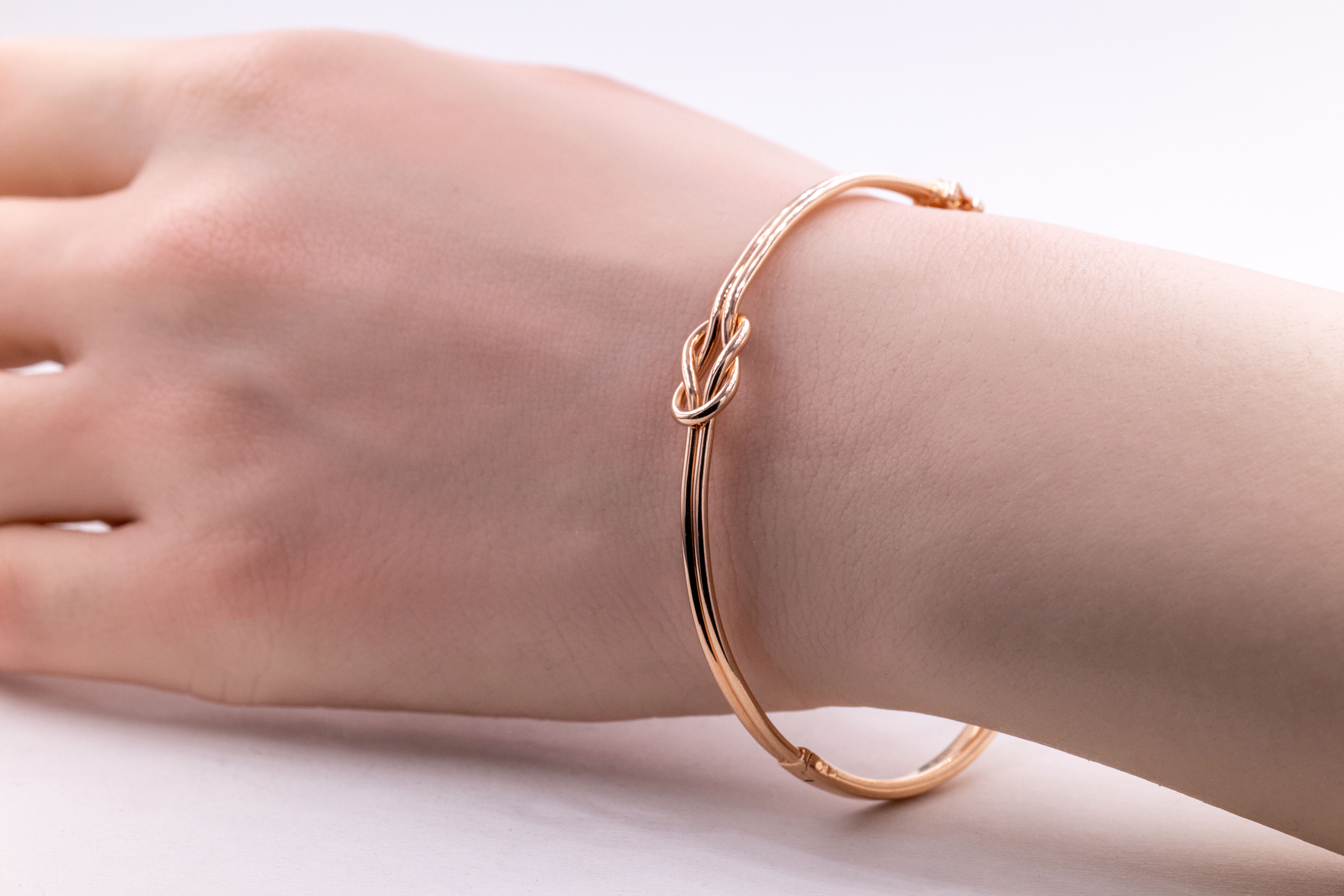 Real 9K Rose Gold Celtic Knot Bracelet For Women With a Polished Finish - Model Photo