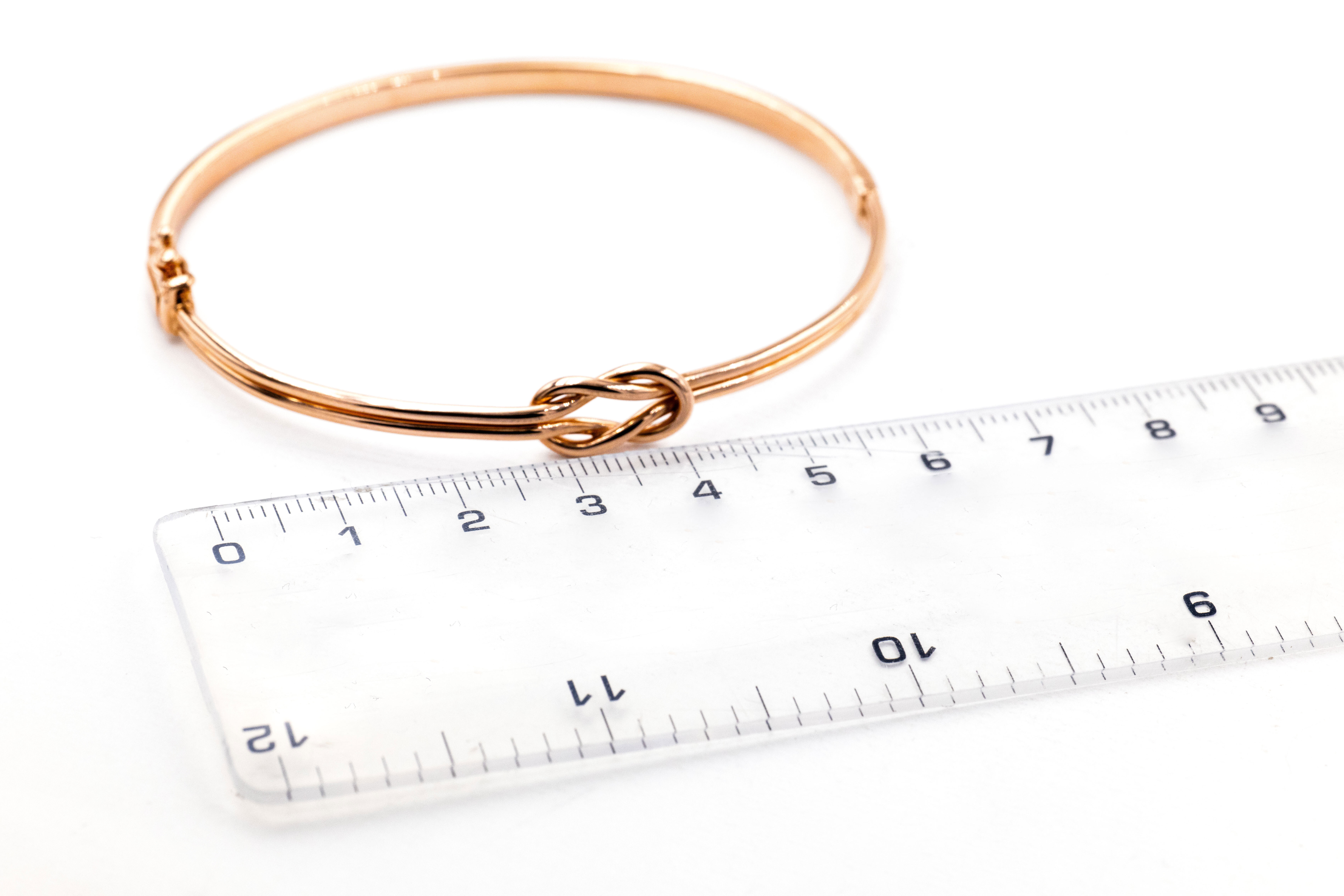 Womens Polished Celtic Knot Bracelet in Real 9K Rose Gold. Picture For Scale.