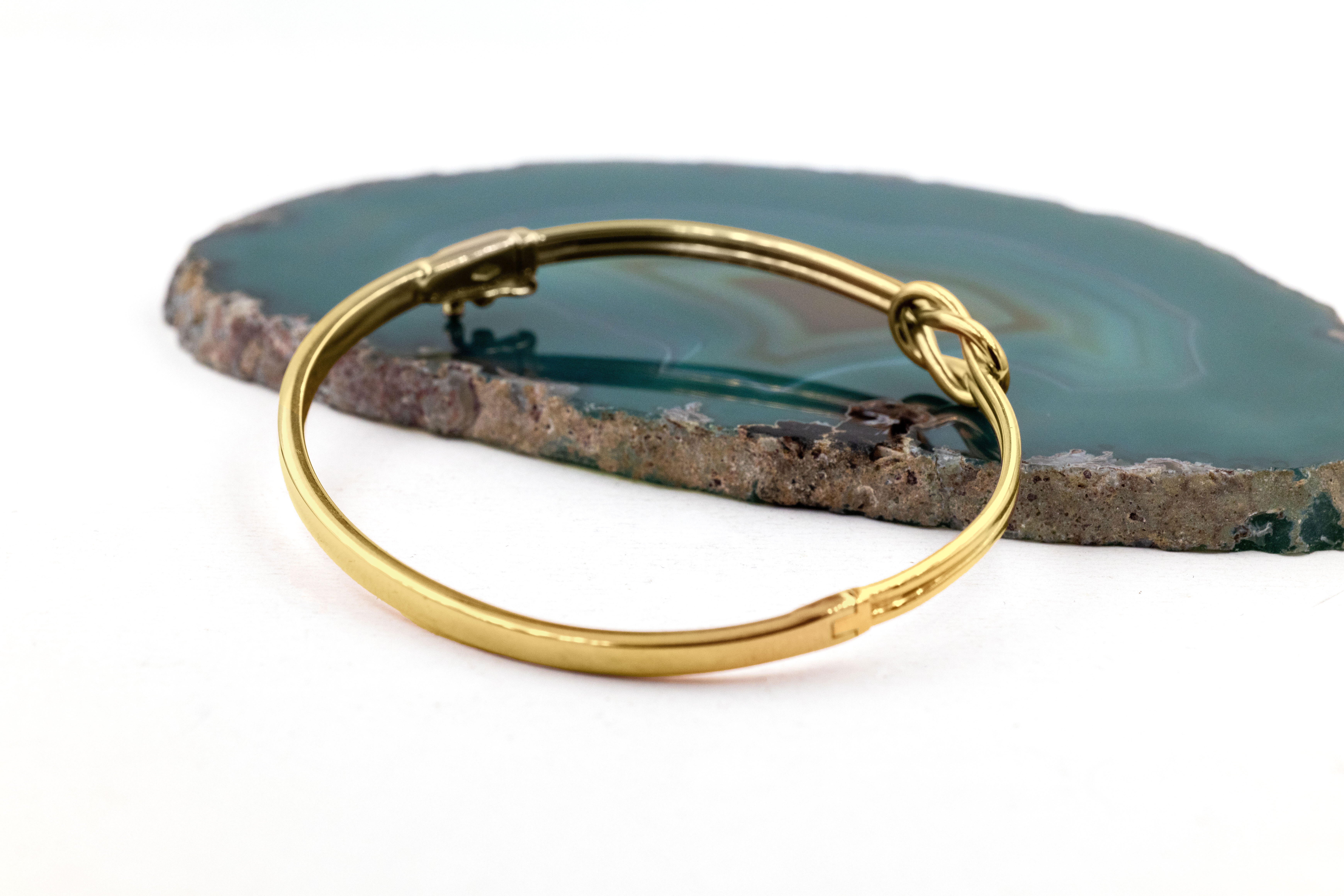 Womens Celtic Knot Bracelet in Yellow Gold With a Polished Finish. Side View.