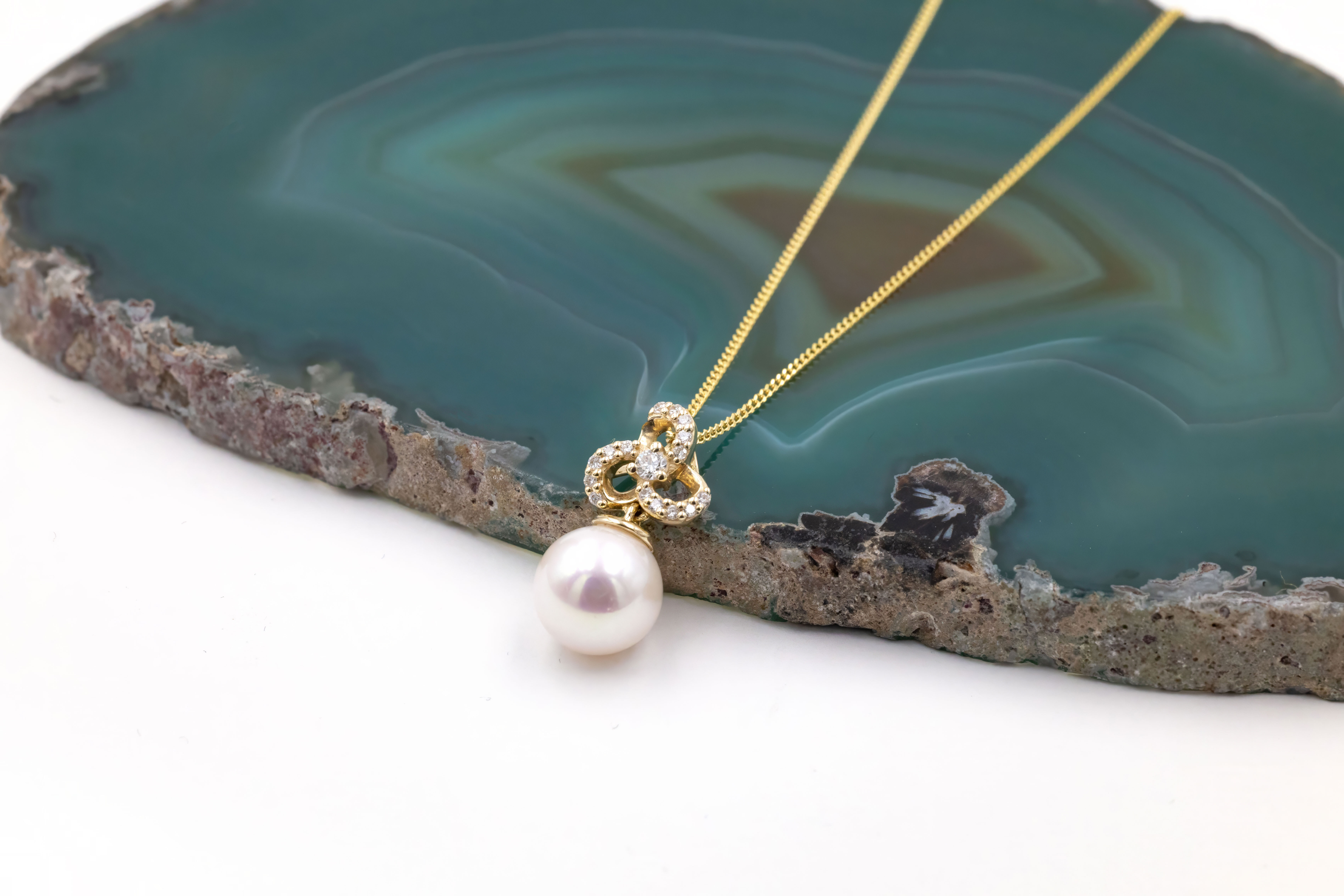 Authentic 9K Yellow Gold Trinity Knot Necklace For Women With a Polished Finish. Pictured Flat.