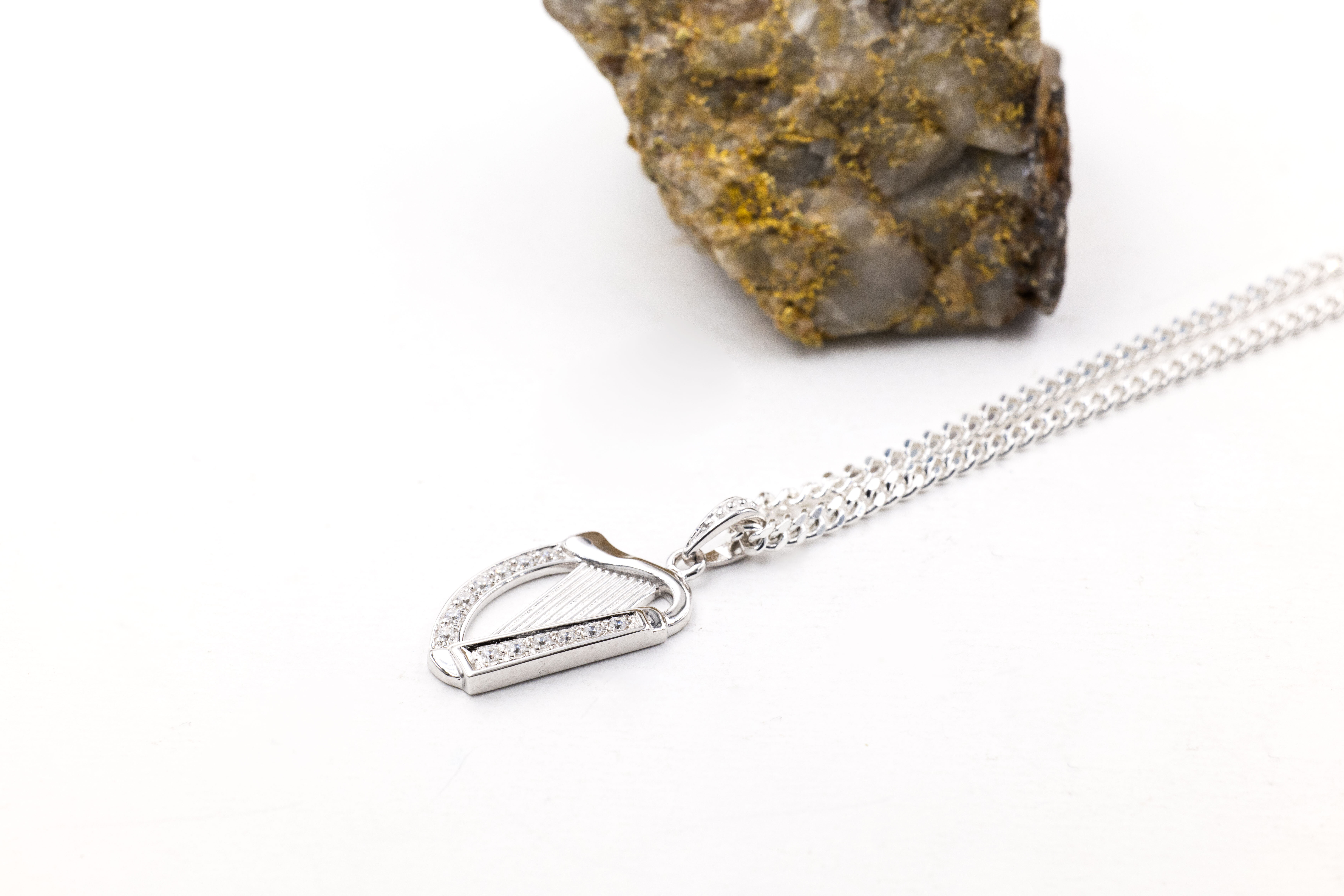 Irish Sterling Silver Irish Harp Necklace With a Polished Finish. Pictured Flat.