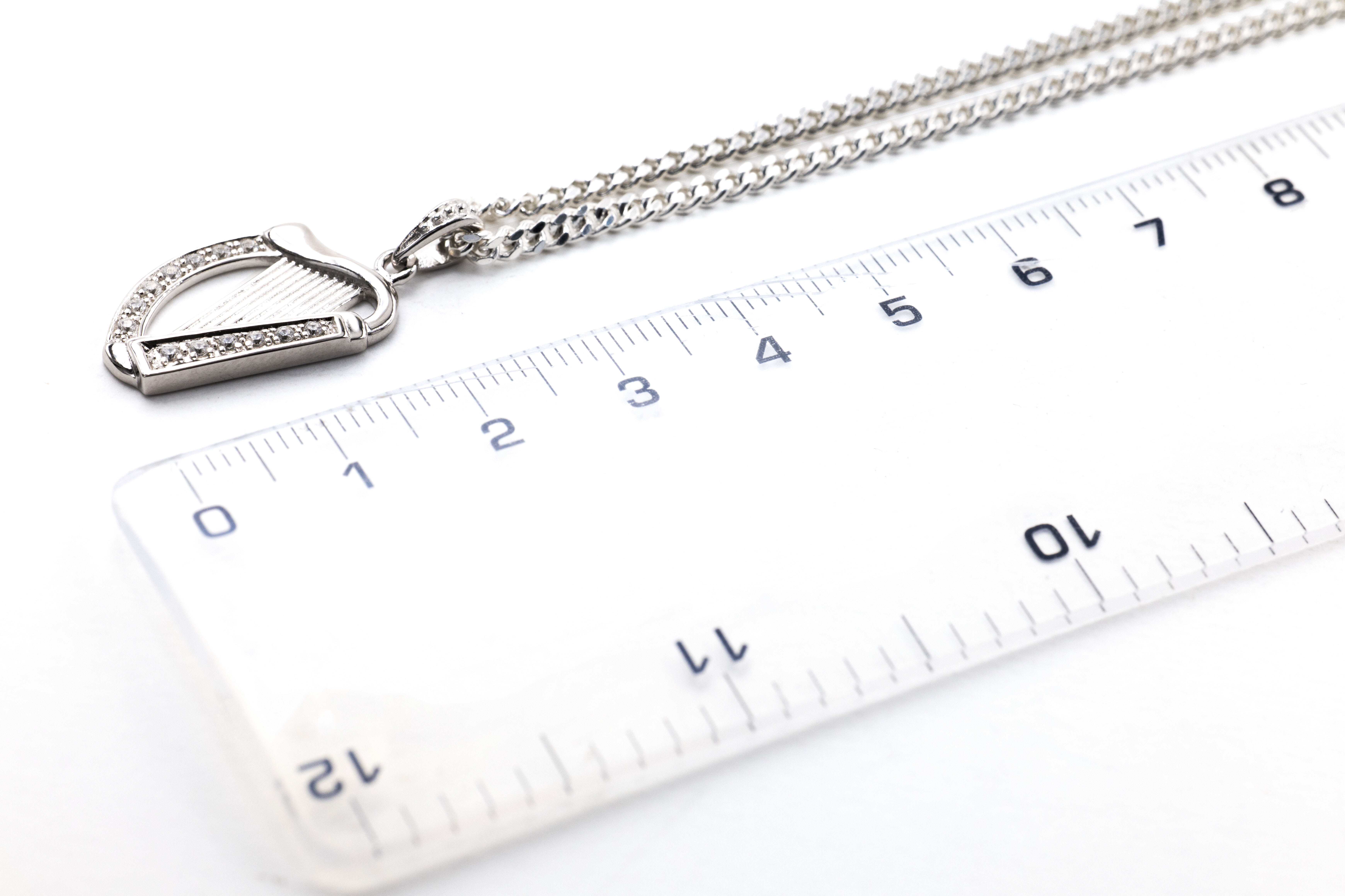 Irish Harp Necklace in Sterling Silver With a Polished Finish. Picture For Scale.