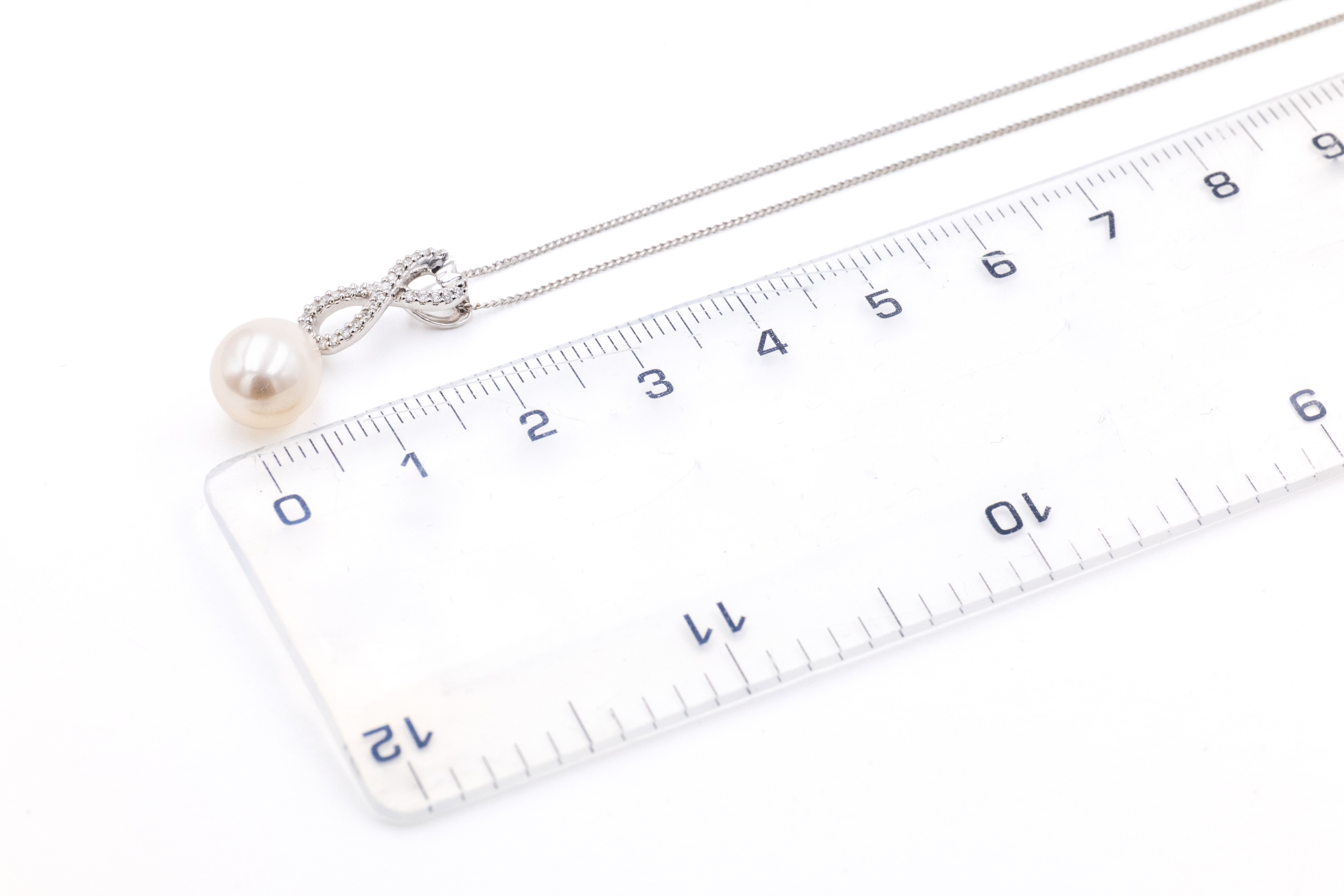 Womens Celtic Knot Necklace in White Gold With a Polished Finish. Picture For Scale.