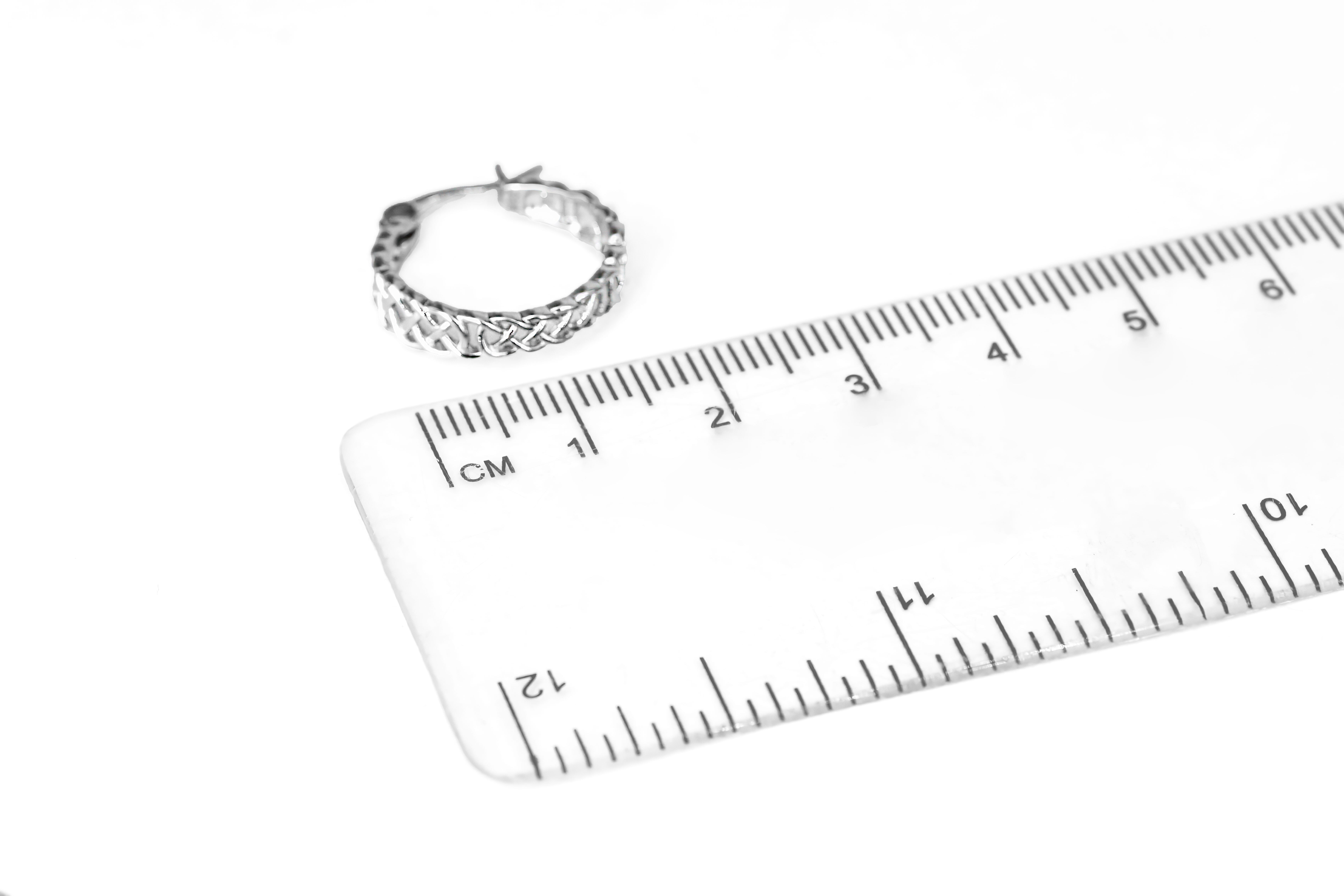 Striking Sterling Silver Celtic Knot Earrings For Women With a Polished Finish. Picture For Scale.