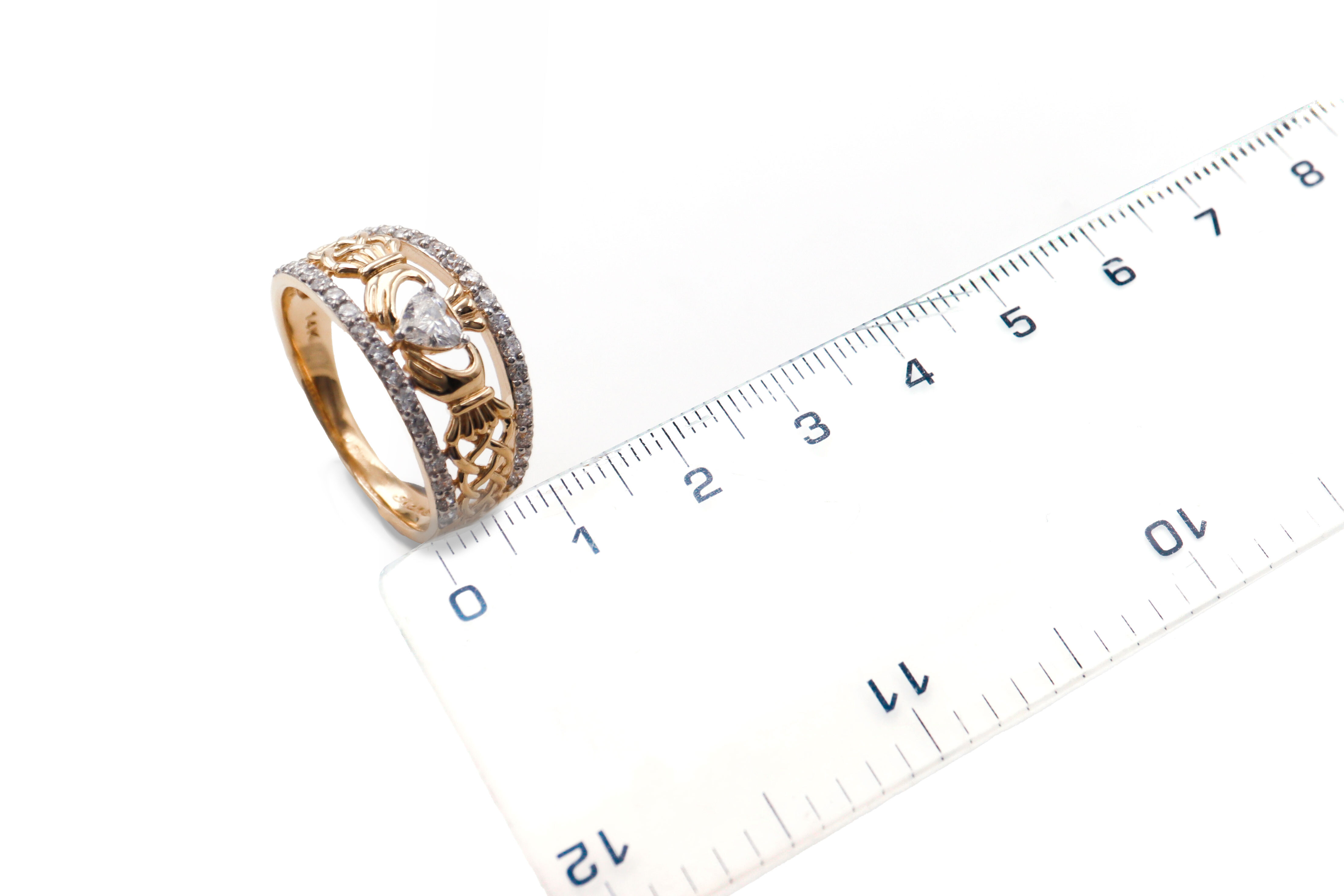 Real 14K Yellow Gold Claddagh & Celtic Knot Anniversary Ring With a Polished Finish For Women. Picture For Scale.