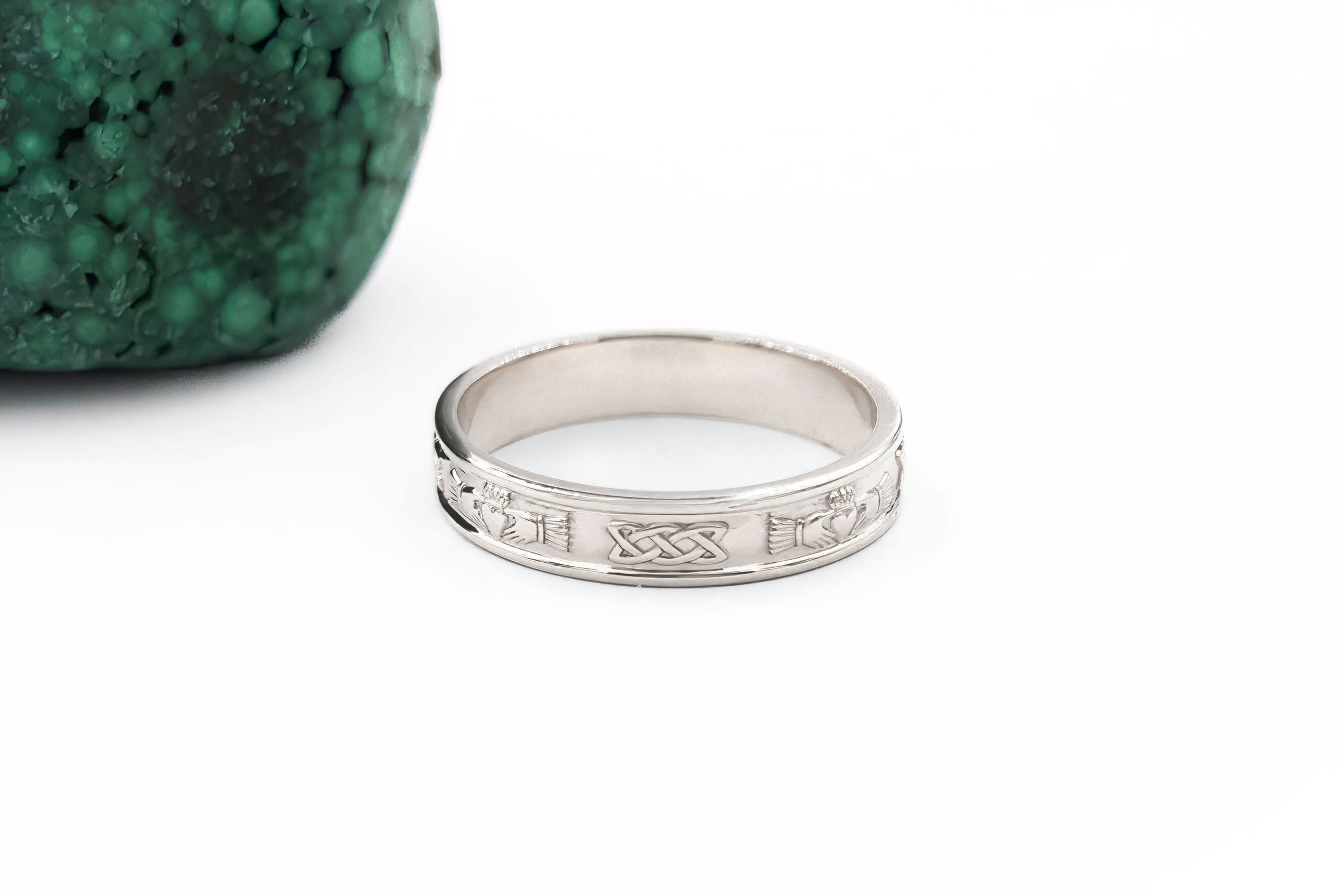 Womens Claddagh 5.0mm Ring in 18K White Gold With a Polished Finish. Side View.