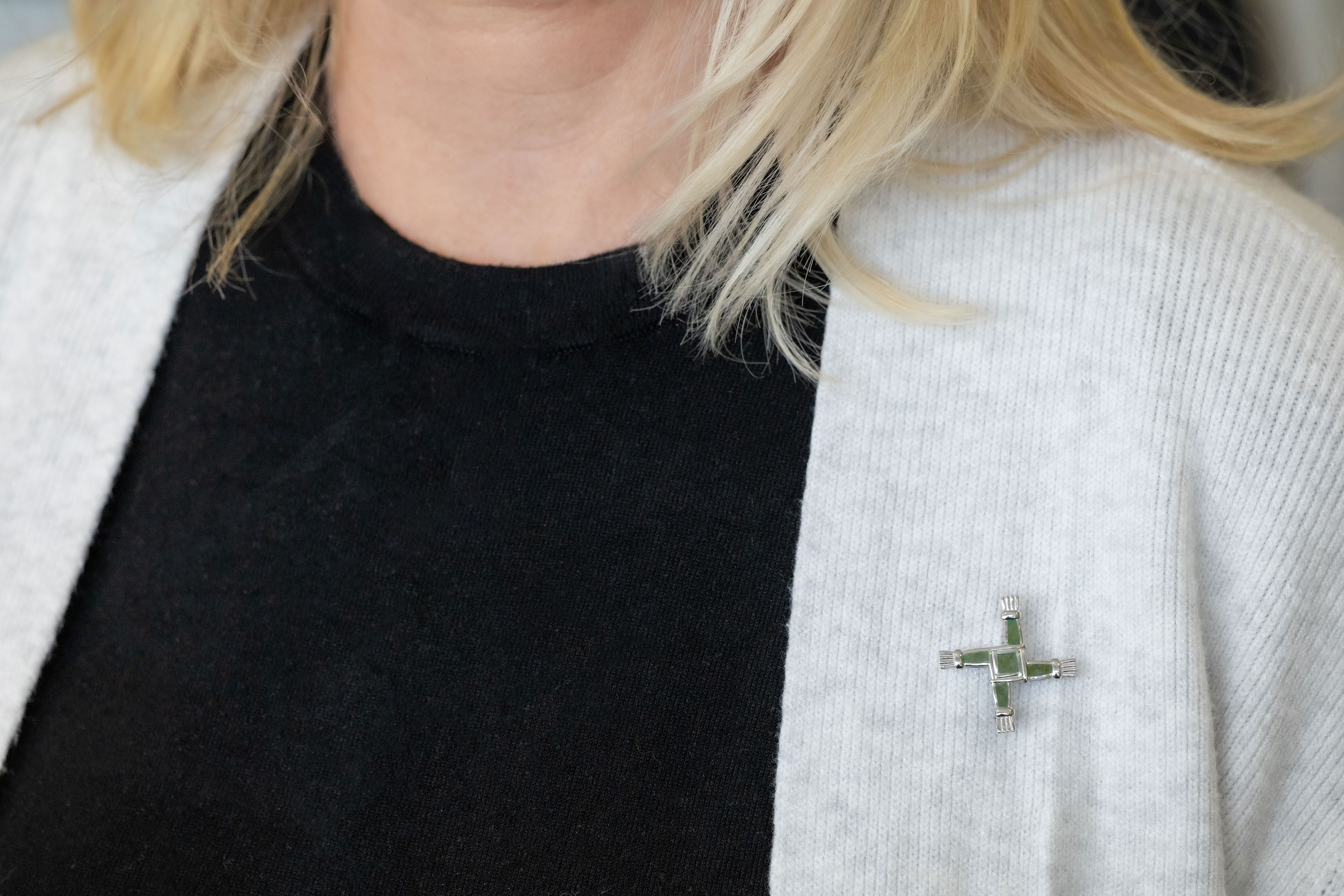 Striking Sterling Silver Connemara Marble & St Brigids Cross Brooch For Women With a Polished Finish - Model Photo