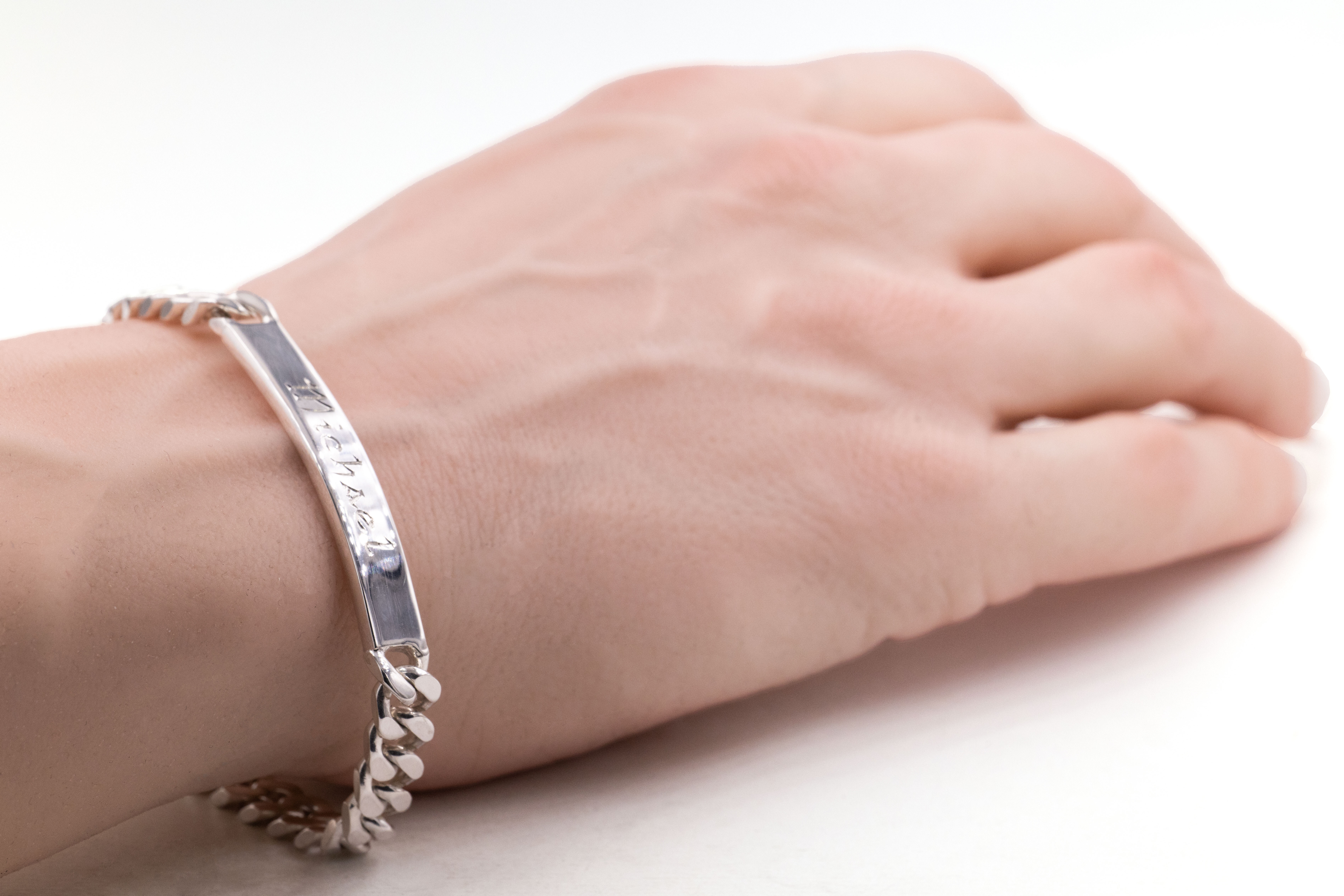 Real Sterling Silver Customisable Gaelic Bracelet For Men With a Polished Finish - Model Photo