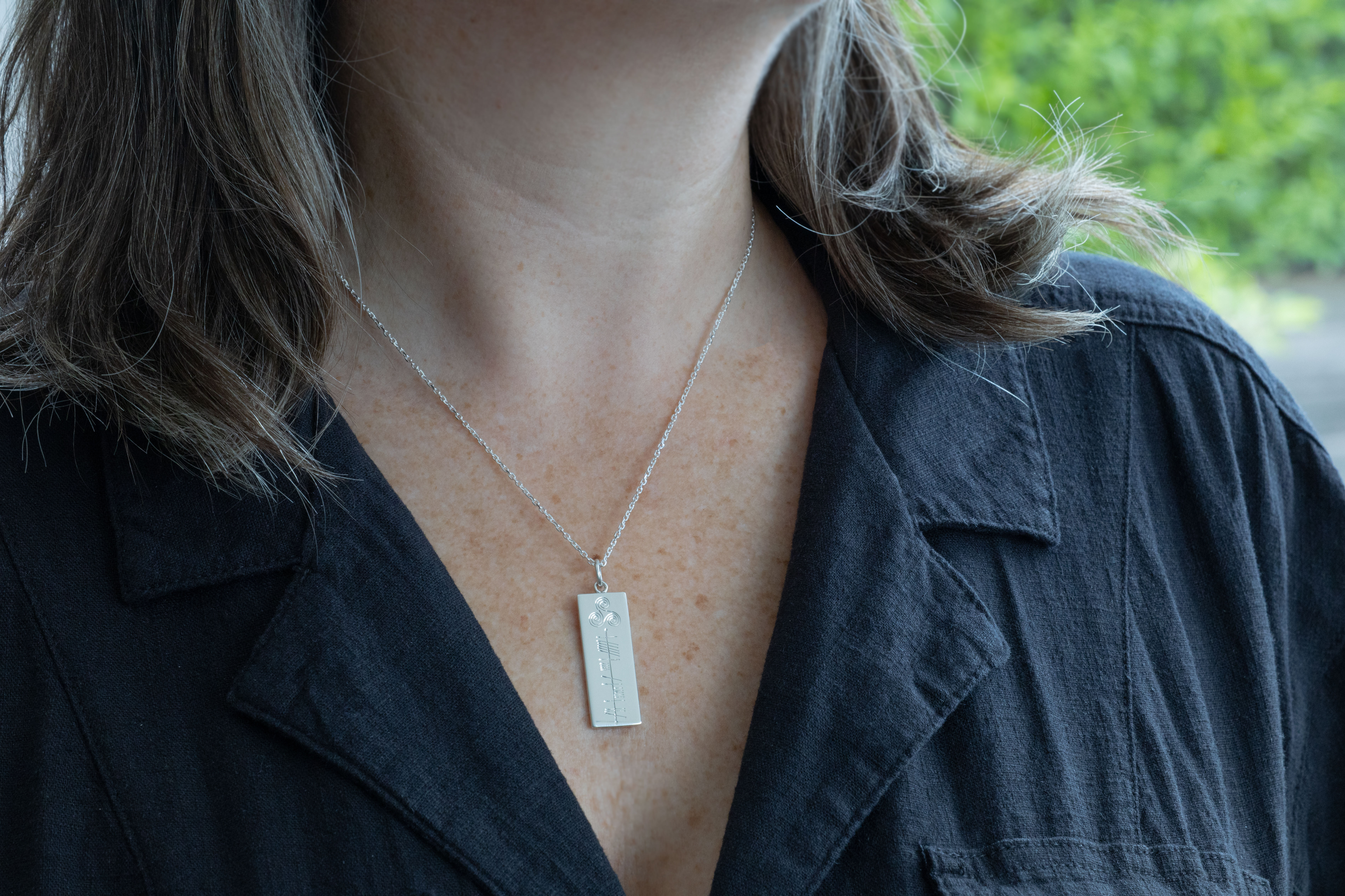 Genuine Sterling Silver Ogham Customizable Necklace With a Polished Finish - Model Photo