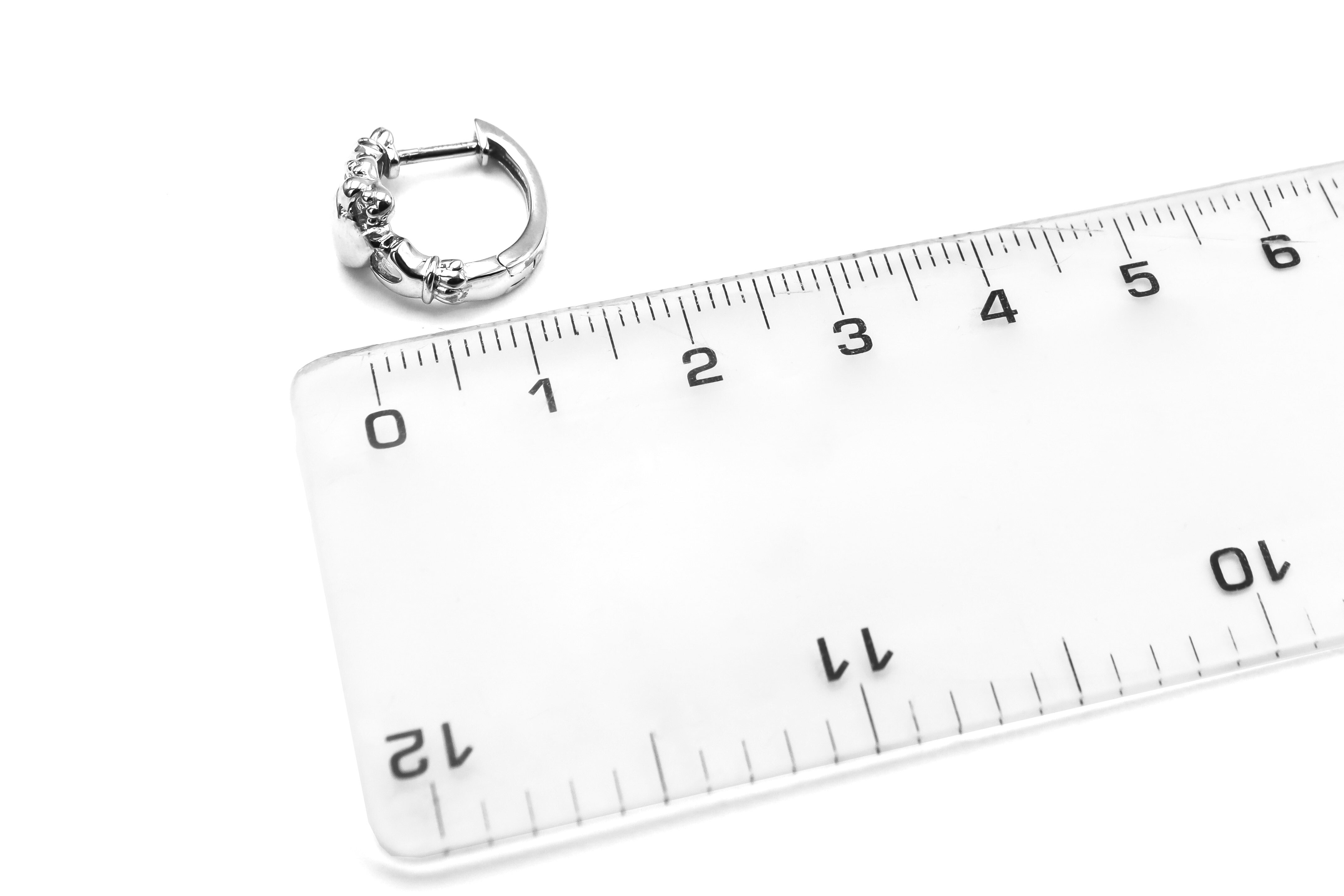 Authentic Sterling Silver Claddagh Earrings For Women With a Polished Finish. Picture For Scale.
