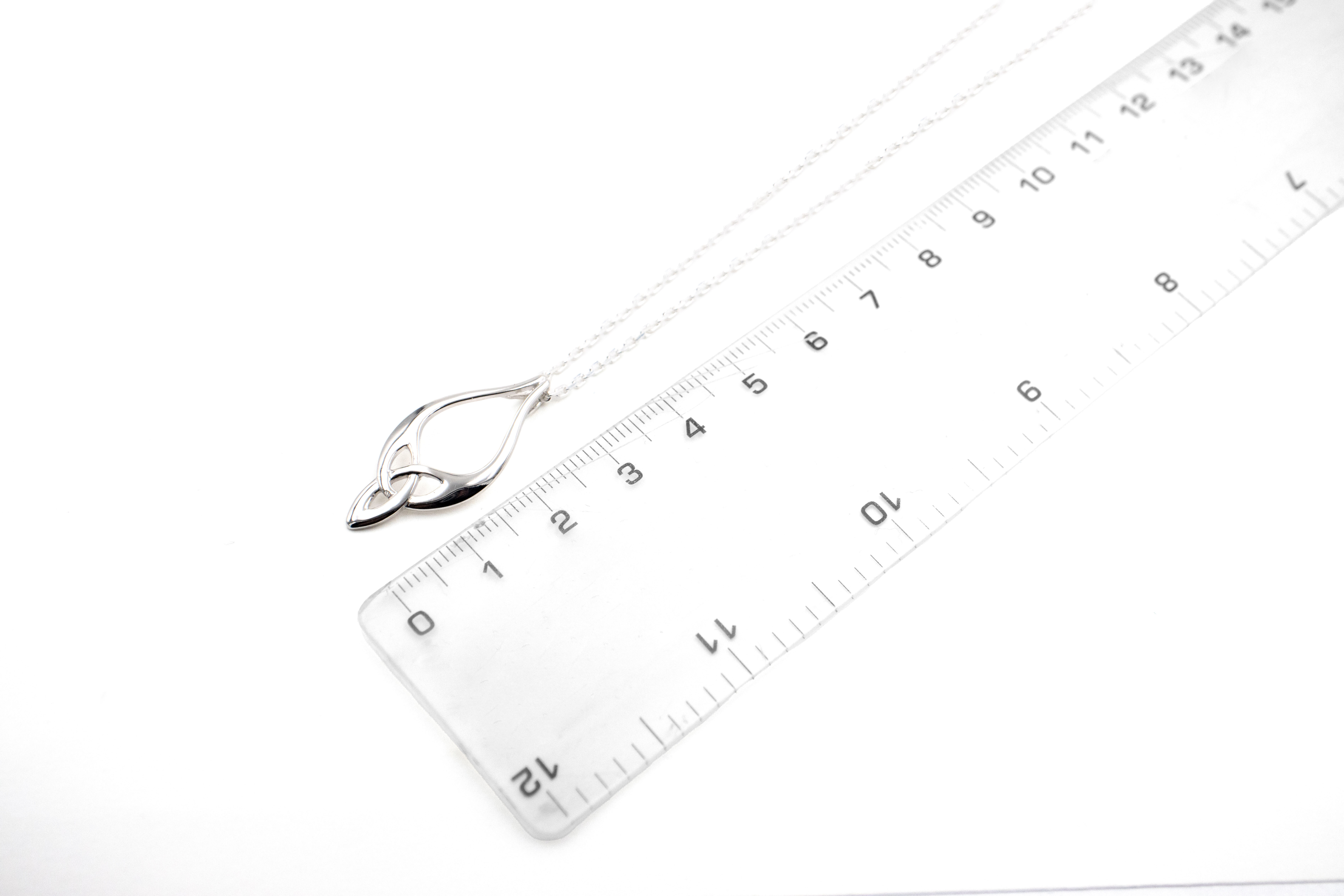 Striking Sterling Silver Trinity Knot Necklace With a Polished Finish For Women. Picture For Scale.