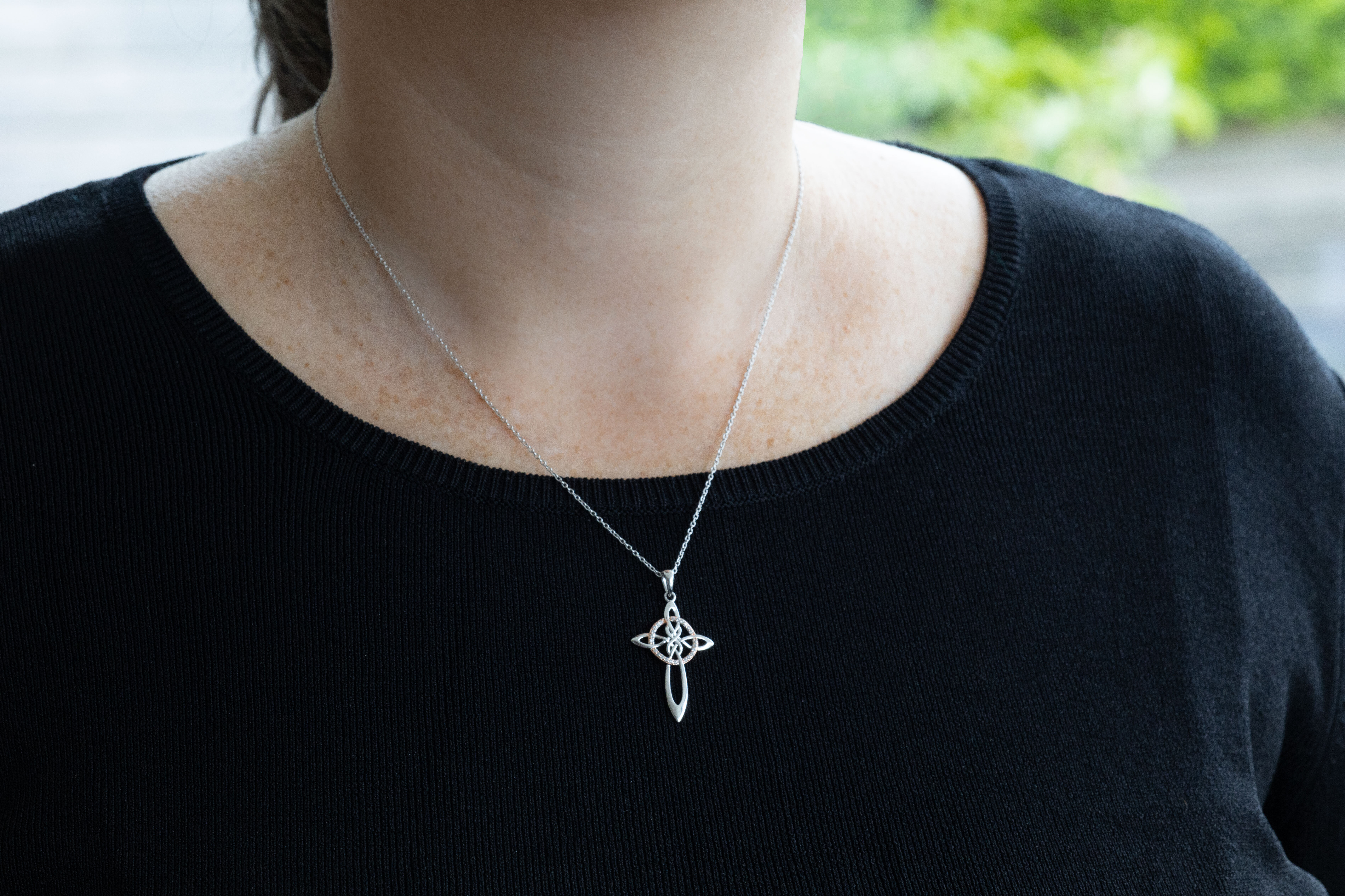 Womens Celtic Cross Necklace in Sterling Silver With a Polished Finish - Model Photo