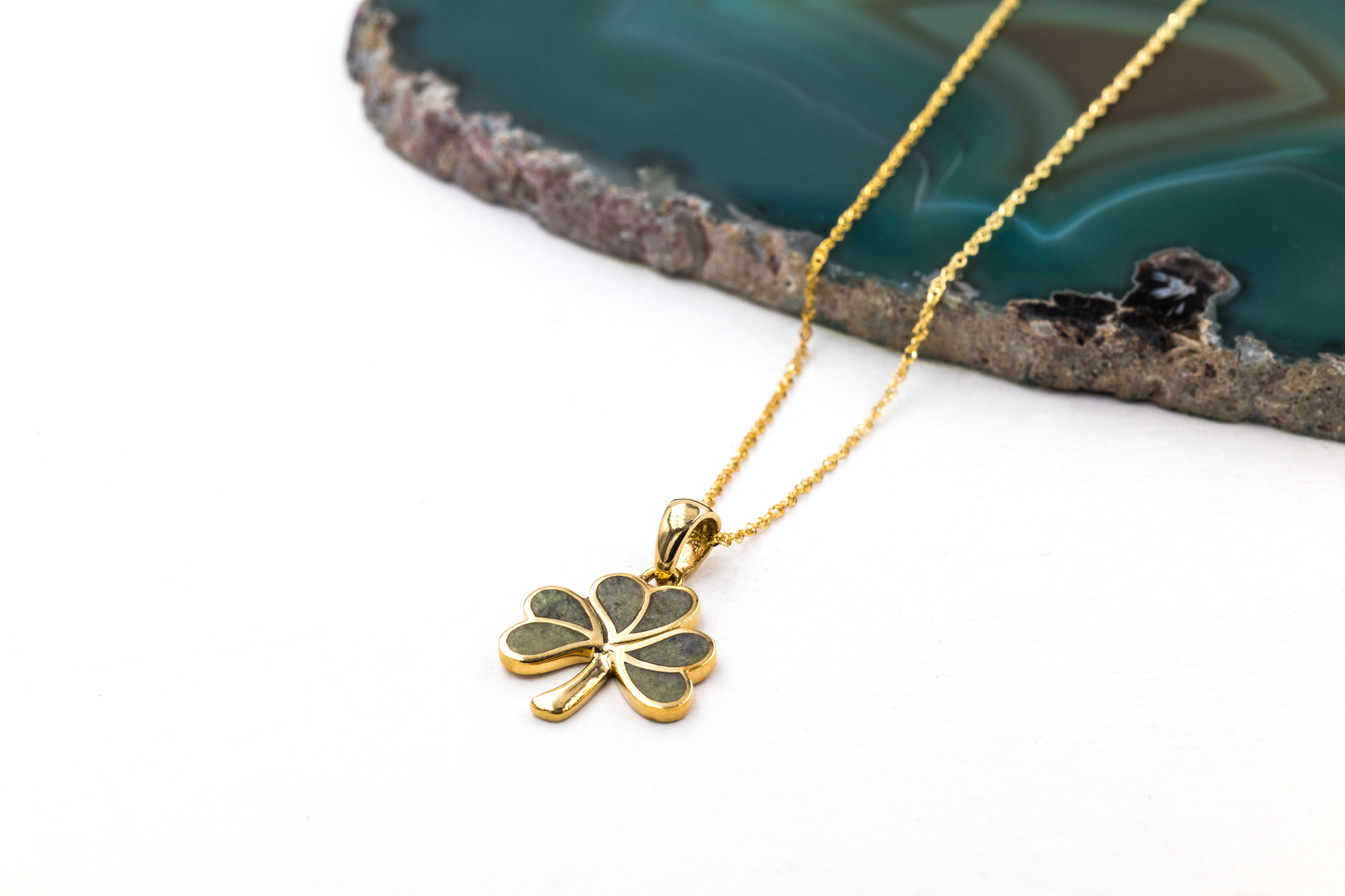 Womens Yellow Gold Shamrock Necklace. Pictured Flat.