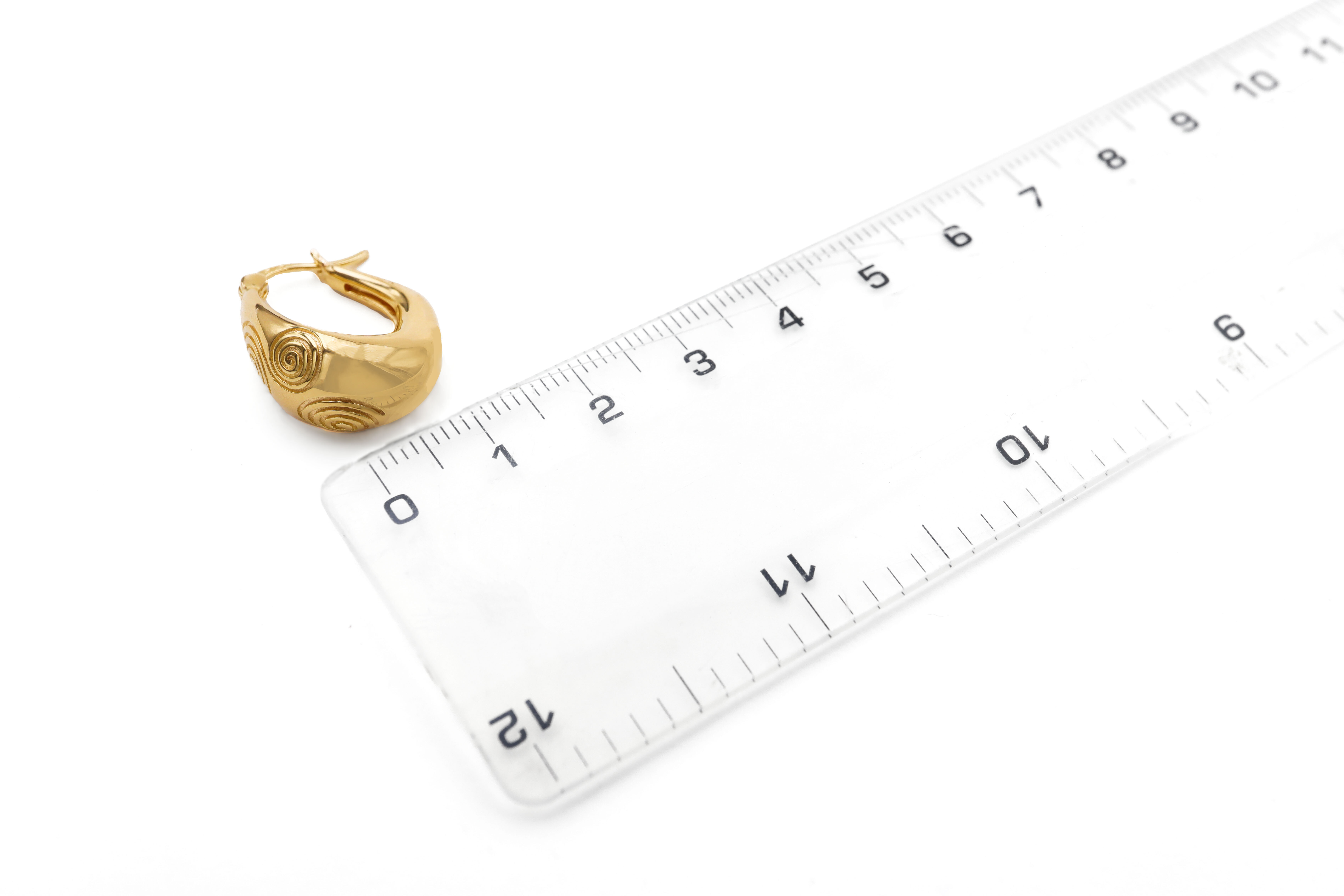 Womens Newgrange & Triskele Earrings in Gold Vermeil With a Polished Finish. Picture For Scale.