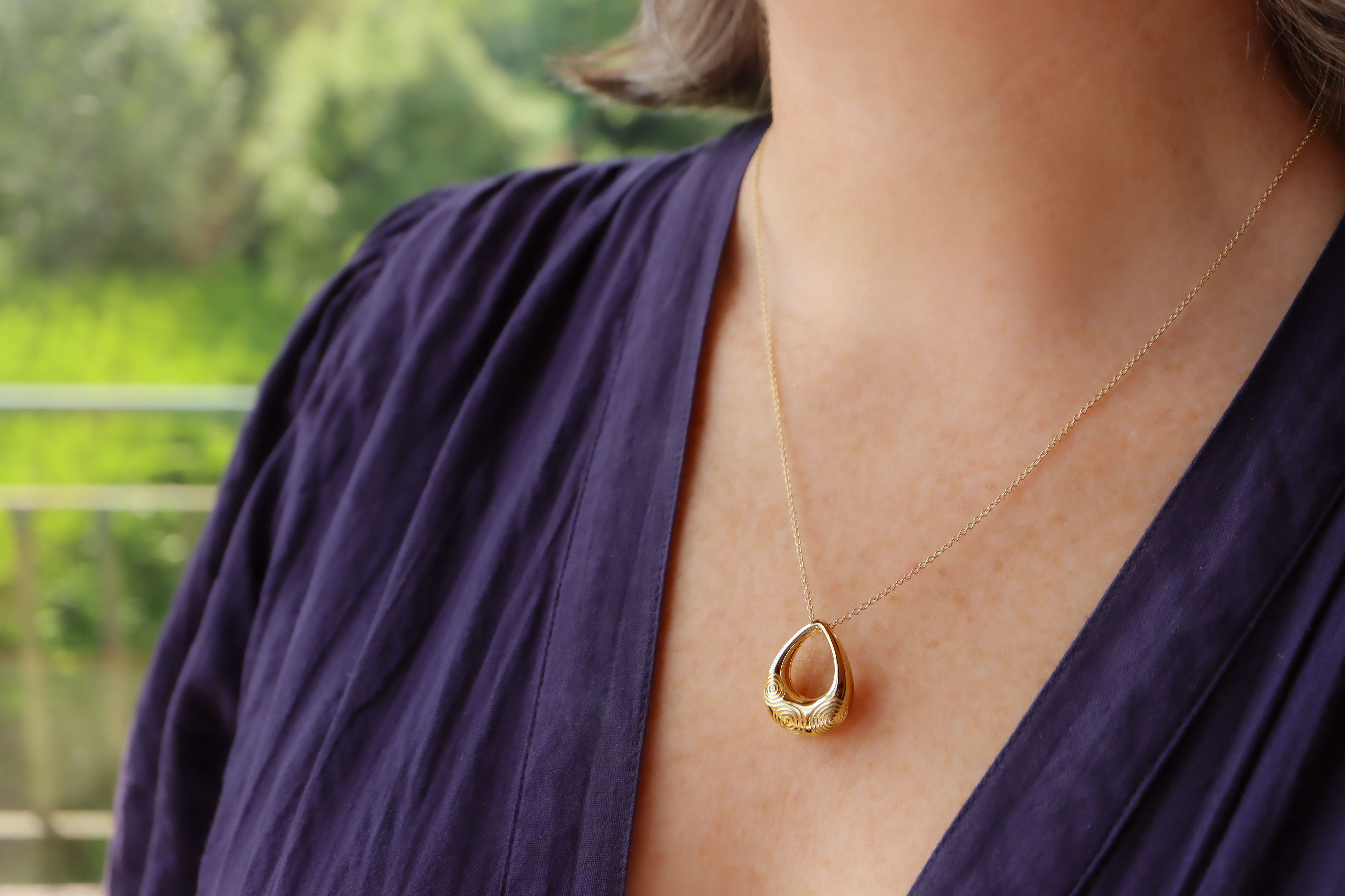 Striking Gold Vermeil Triskele & Newgrange Necklace With a Polished Finish For Women - Model Photo