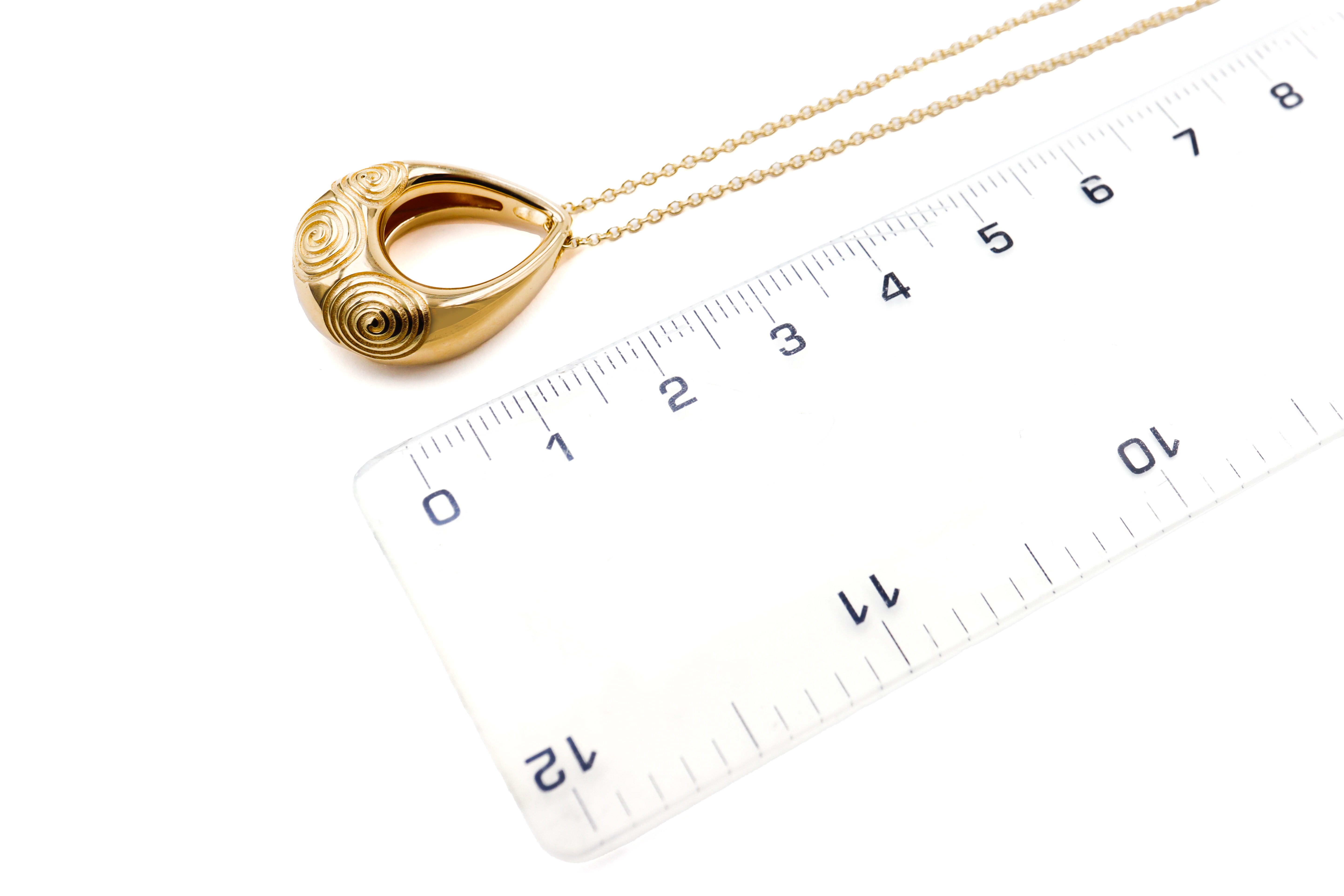 Striking Gold Vermeil Triskele Necklace For Women With a Polished Finish. Picture For Scale.