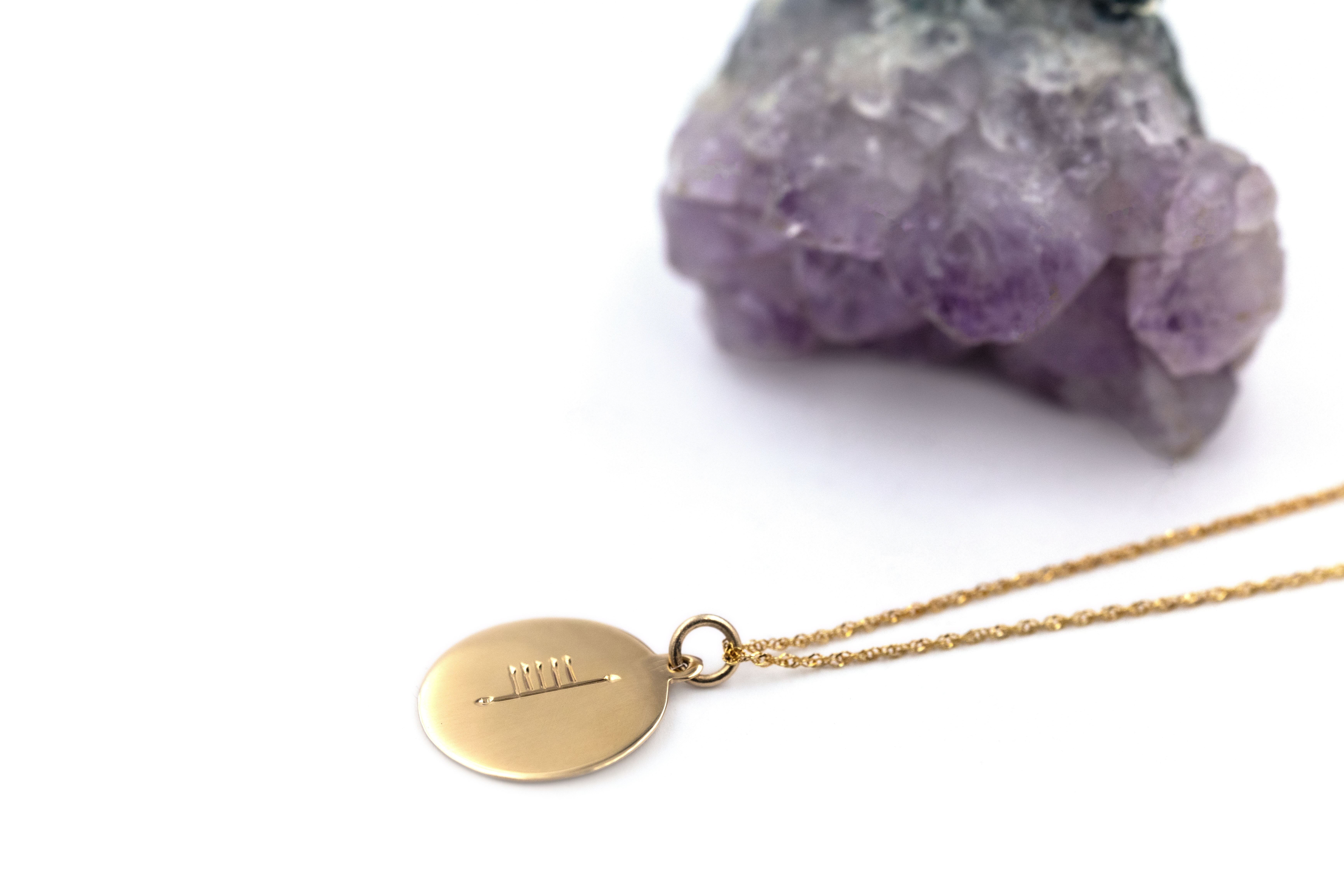 Genuine Yellow Gold Customizable Ogham Necklace With a Polished Finish. Pictured Flat.