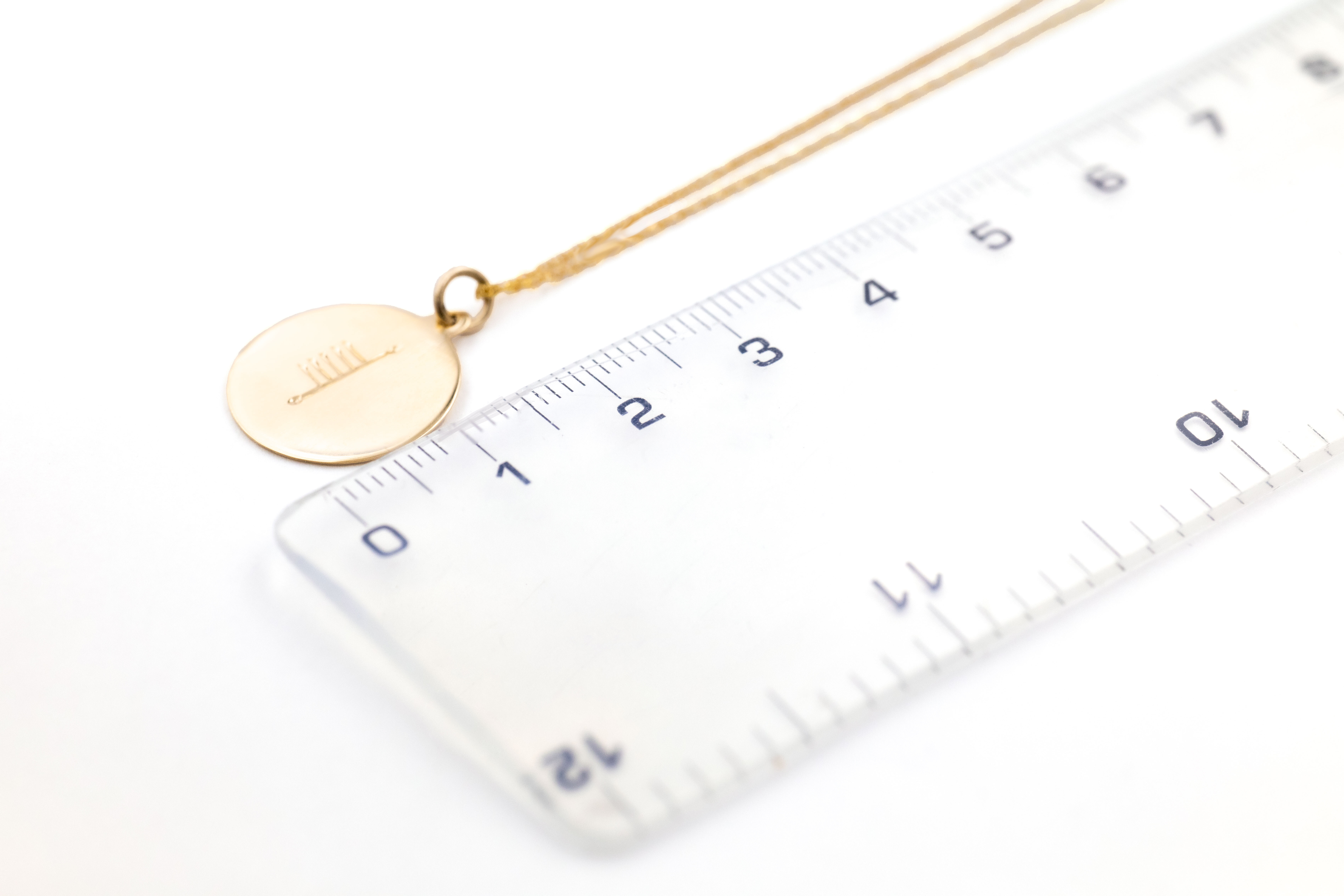 Gorgeous Yellow Gold Ogham Necklace With a Polished Finish. Picture For Scale.
