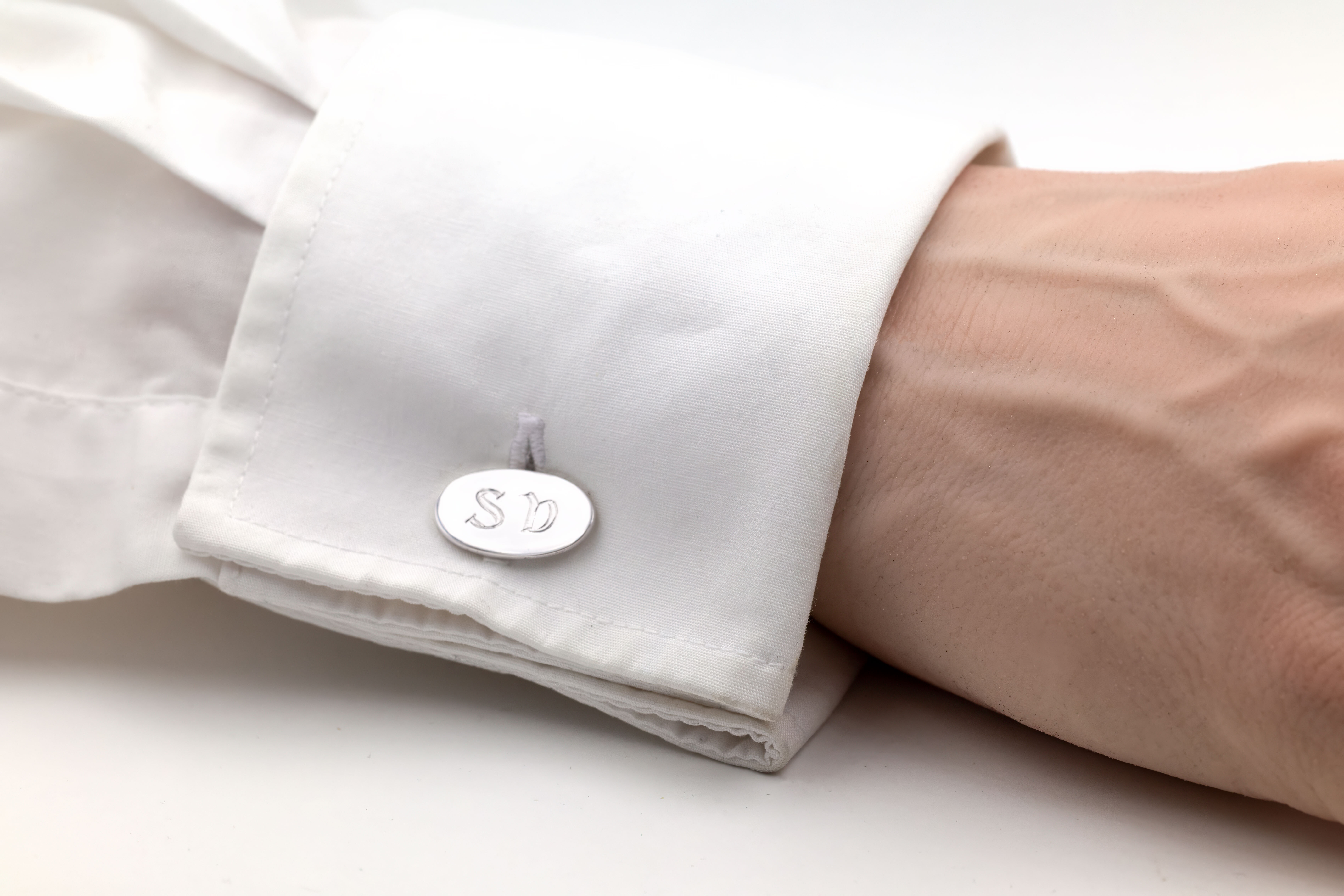 Mens Gaelic Cufflinks in Sterling Silver With a Polished Finish - Model Photo