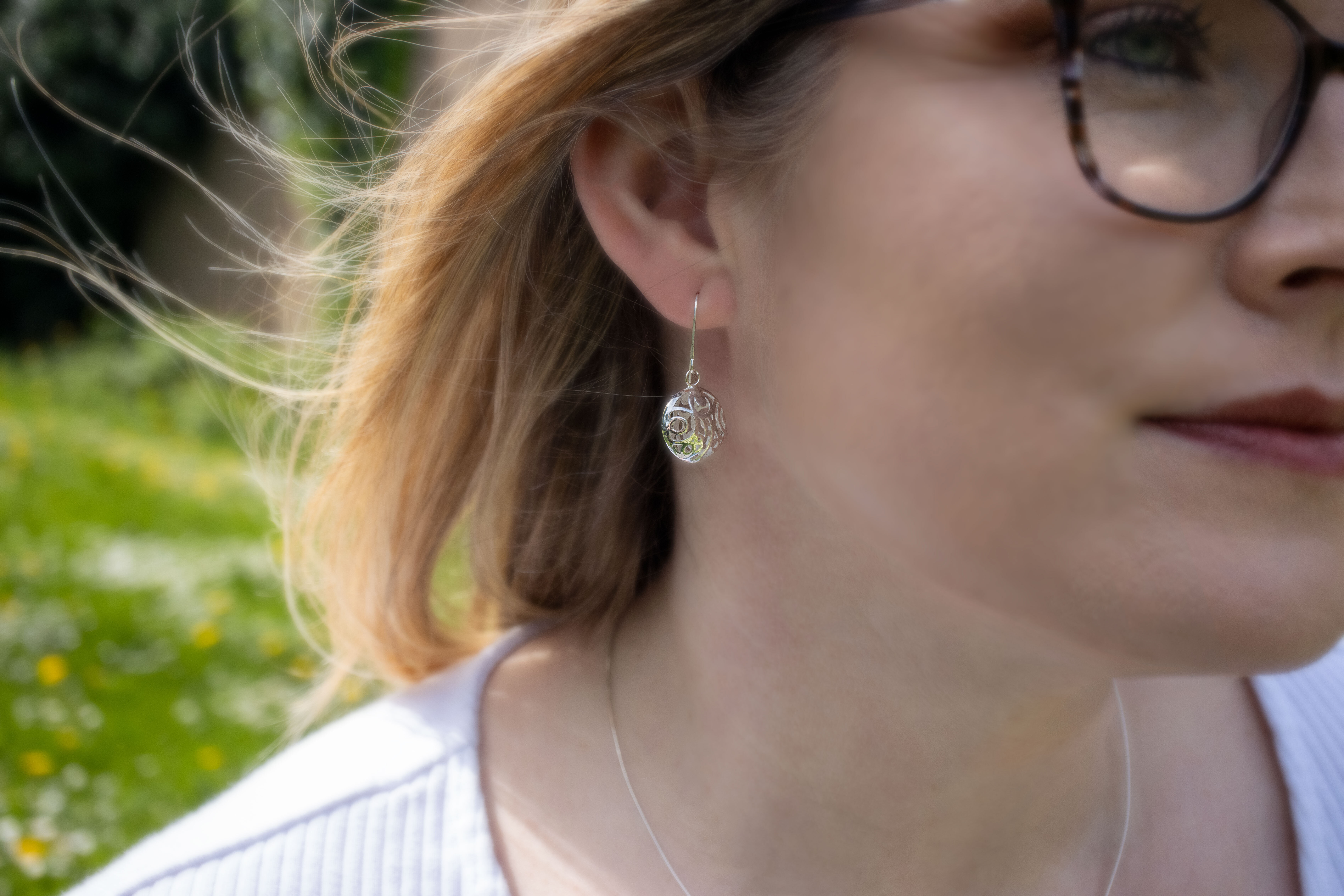 Attractive Sterling Silver Folklore Earrings For Women With a Polished Finish - Model Photo