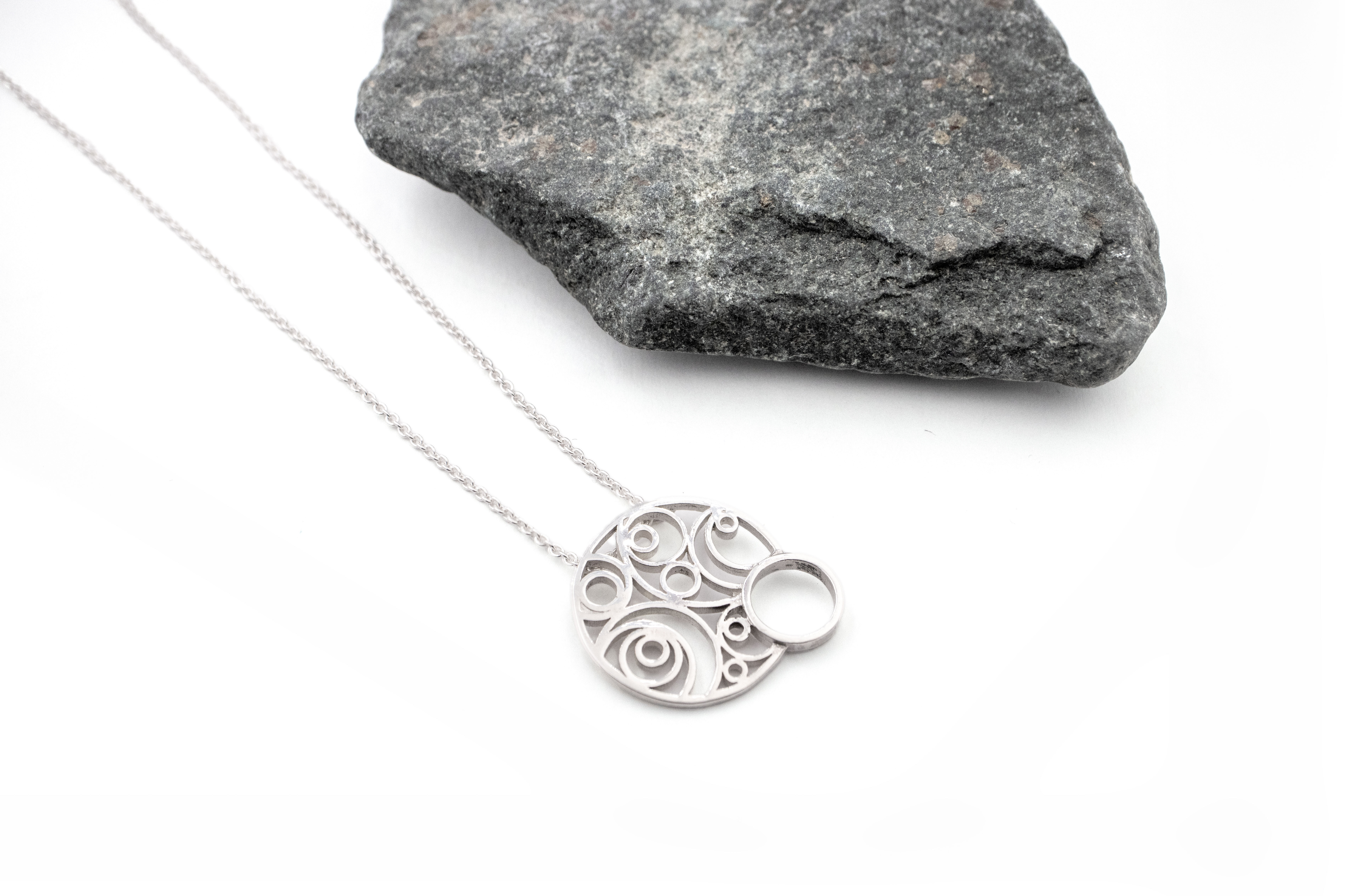Striking Sterling Silver Folklore Necklace For Women With a Polished Finish. Pictured Flat.