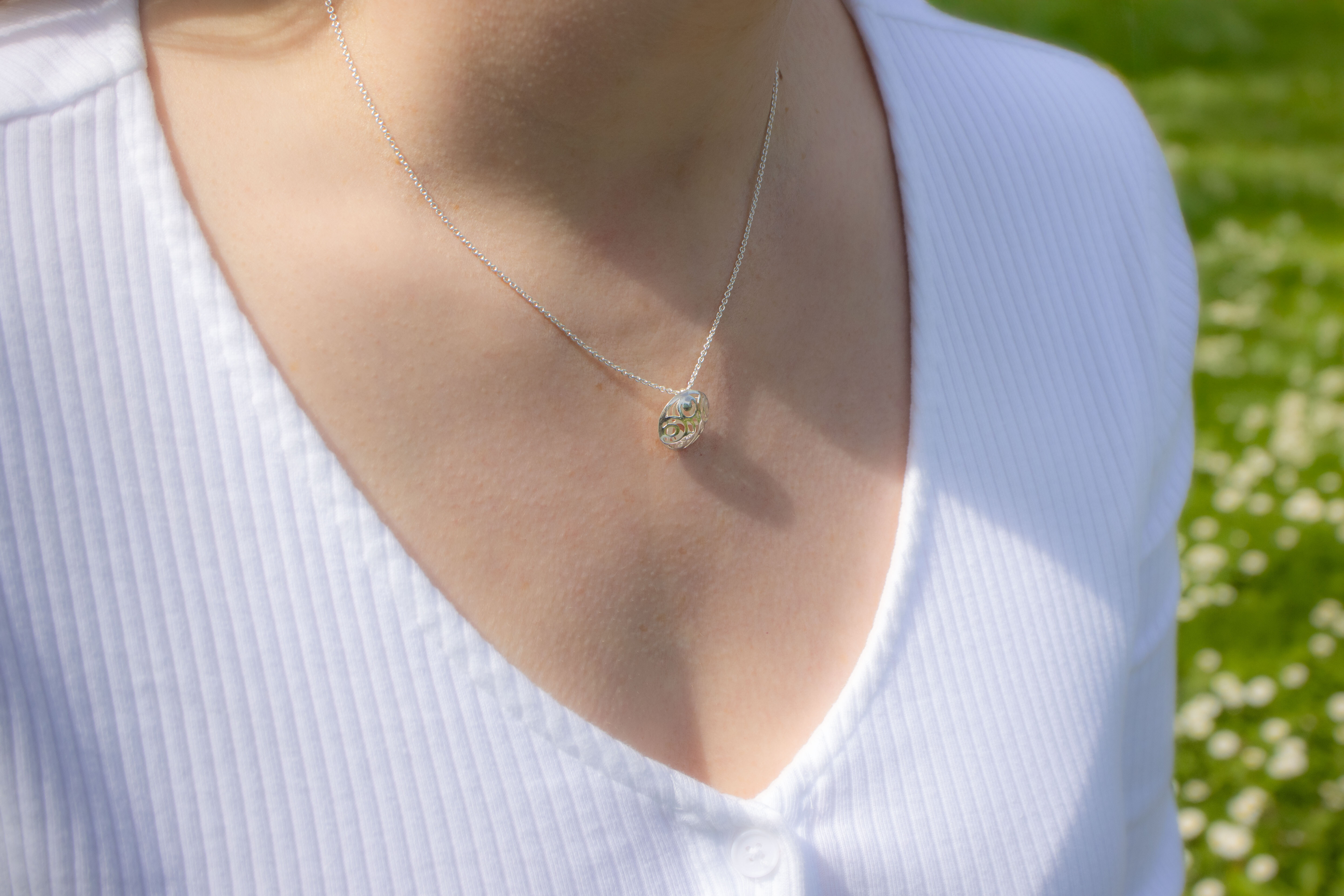 Irish Sterling Silver Newgrange & Folklore Necklace With a Polished Finish For Women - Model Photo