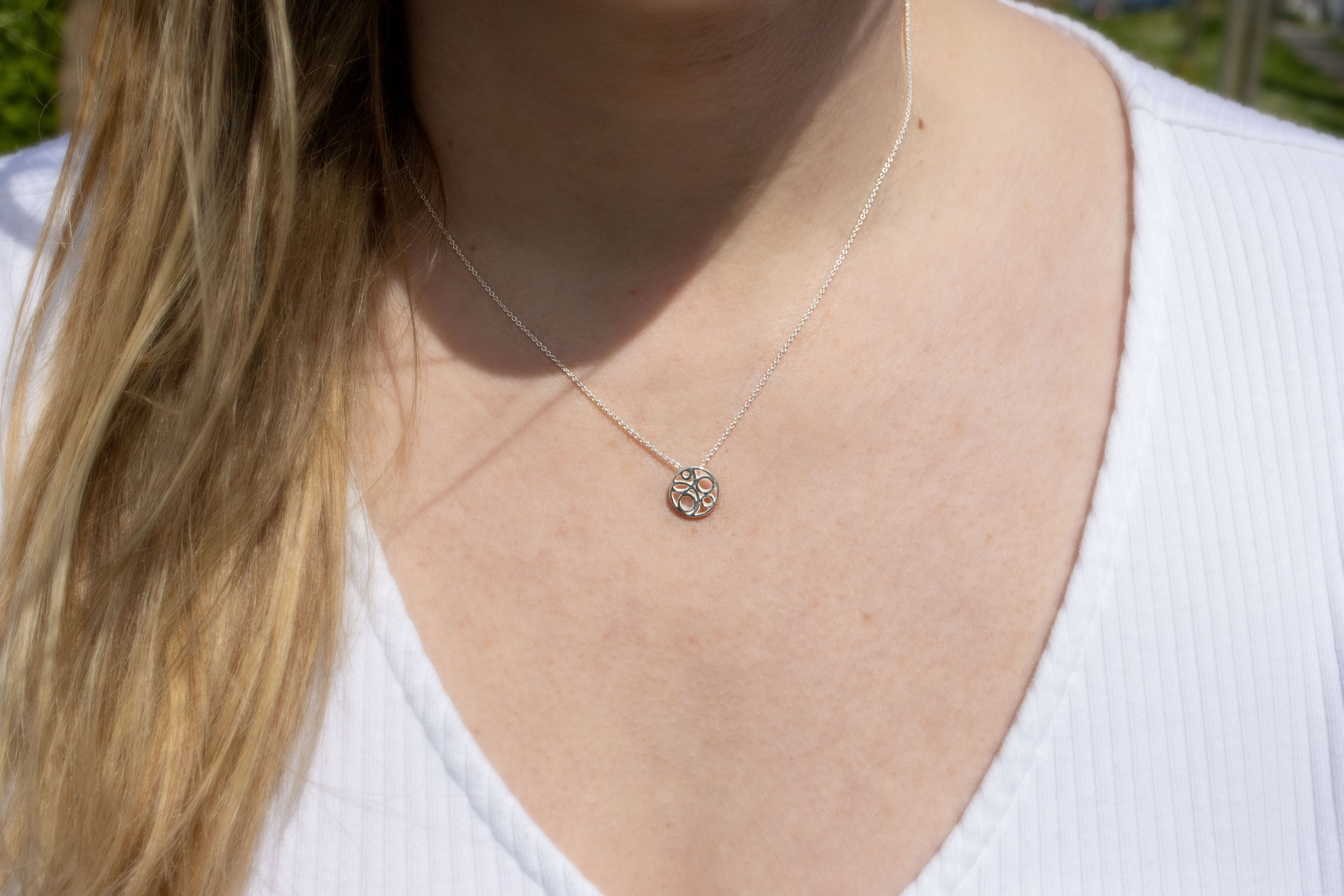Small Striking Sterling Silver Folklore Necklace For Women With a Polished Finish - Model Photo
