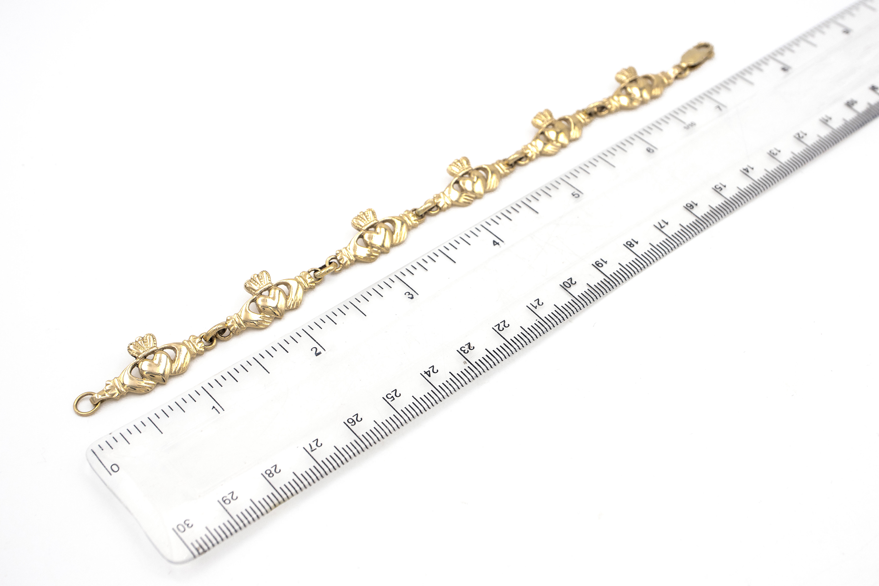 Womens Yellow Gold Claddagh Bracelet. Picture For Scale.