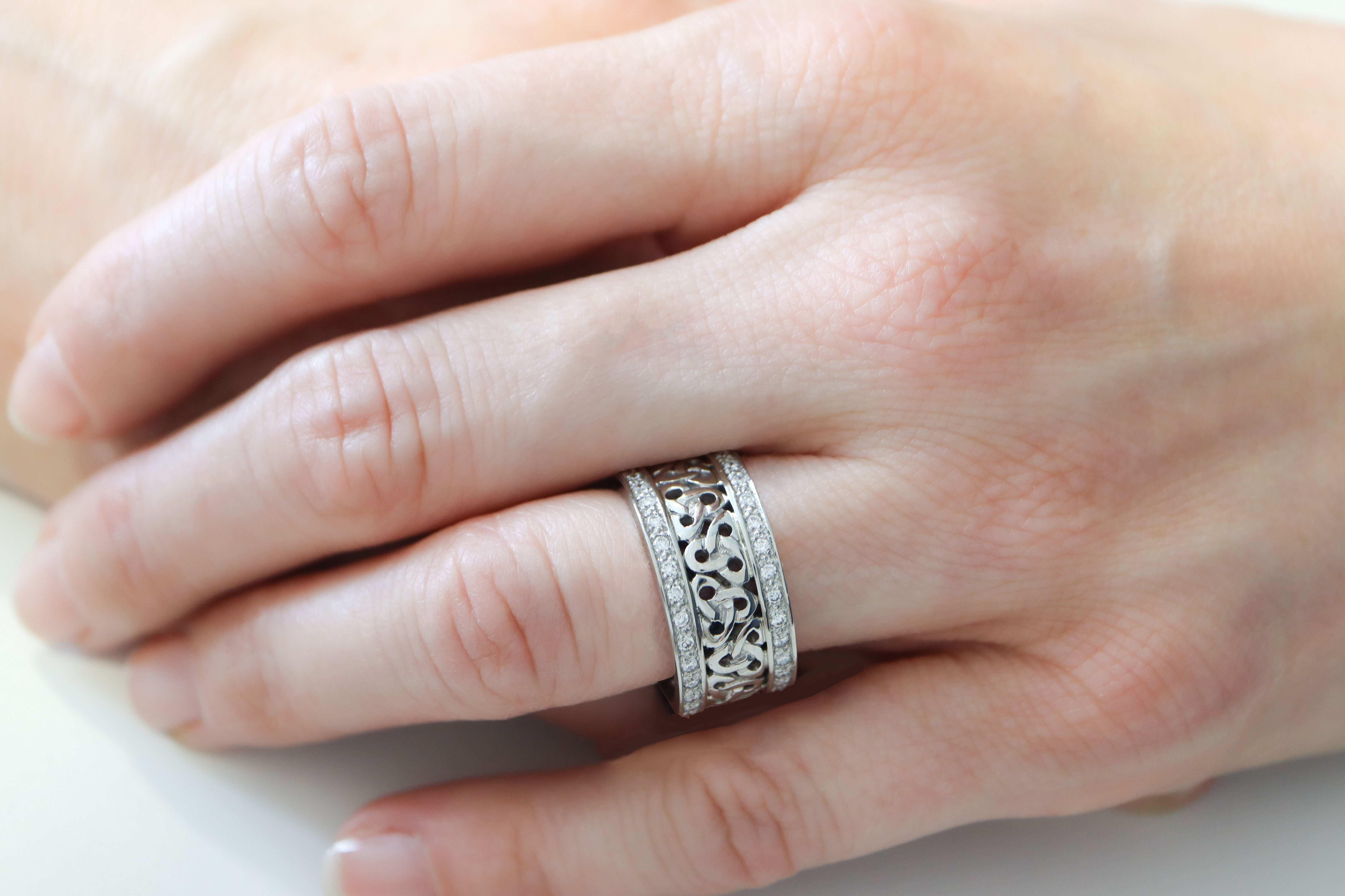 Irish Platinum Trinity Knot Ring With a Polished Finish - Model Photo