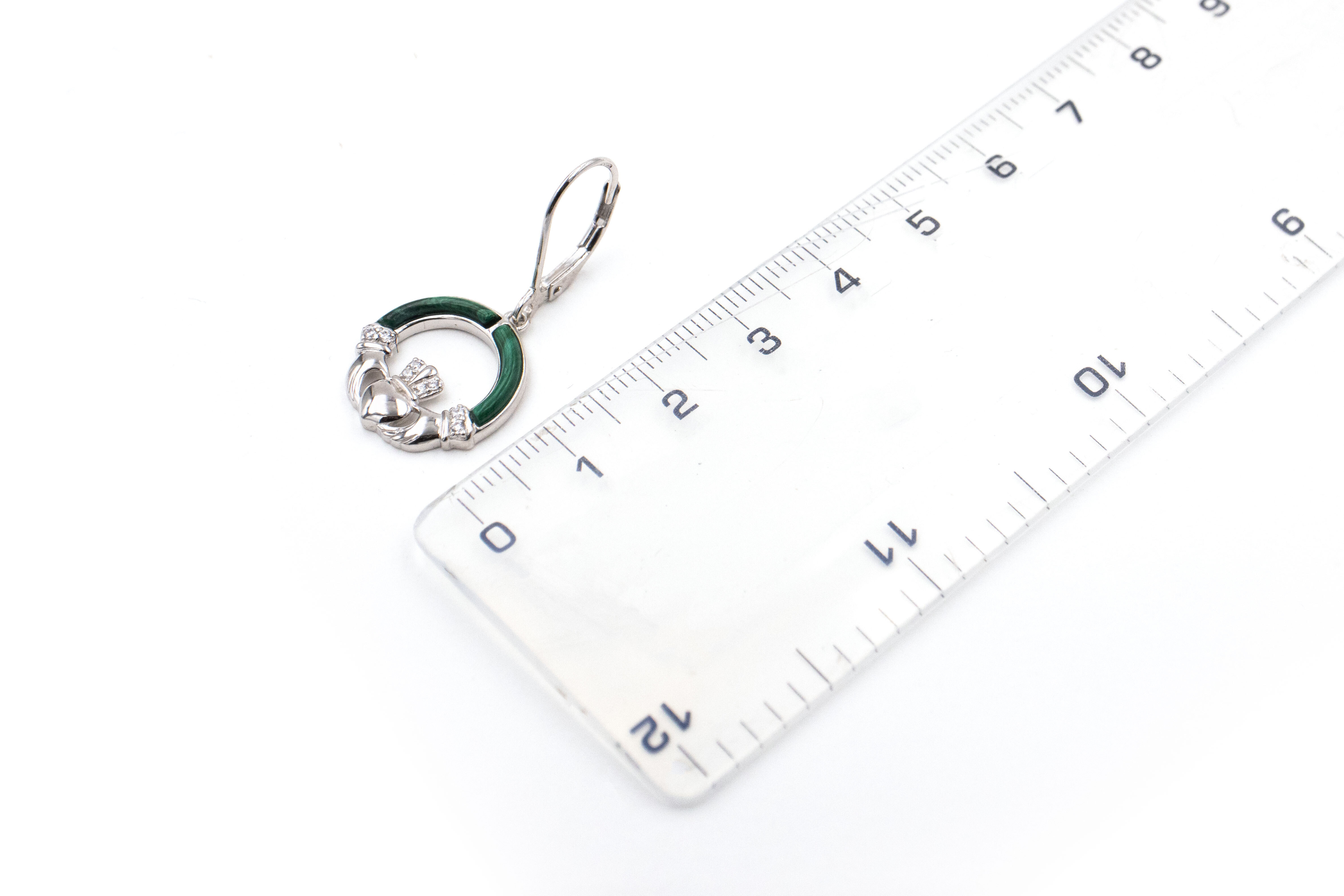 Genuine Sterling Silver Claddagh Earrings For Women With a Polished Finish. Picture For Scale.