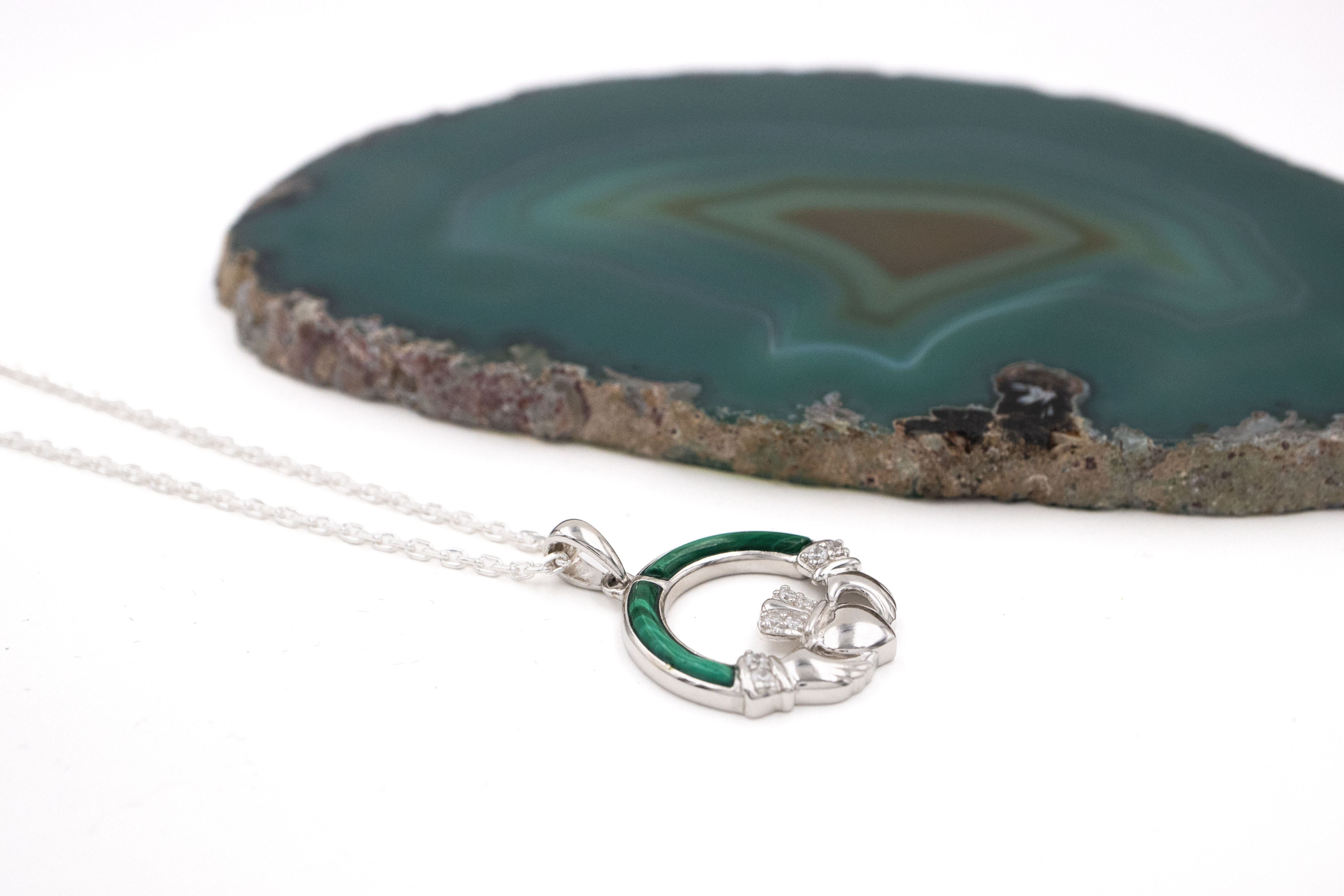 Womens Claddagh Necklace in Sterling Silver With a Polished Finish. Pictured Flat.