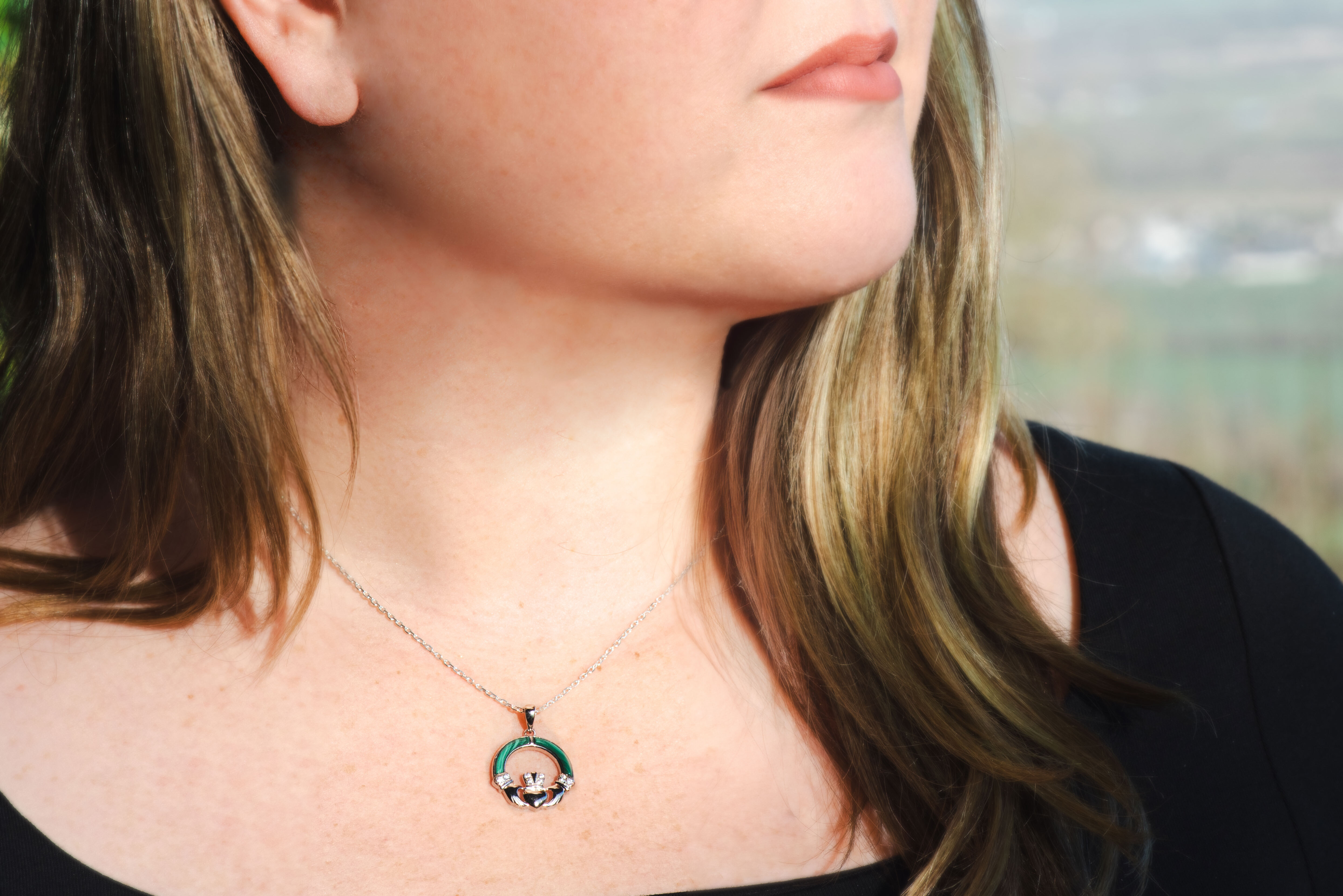 Womens Claddagh Necklace in Sterling Silver With a Polished Finish - Model Photo