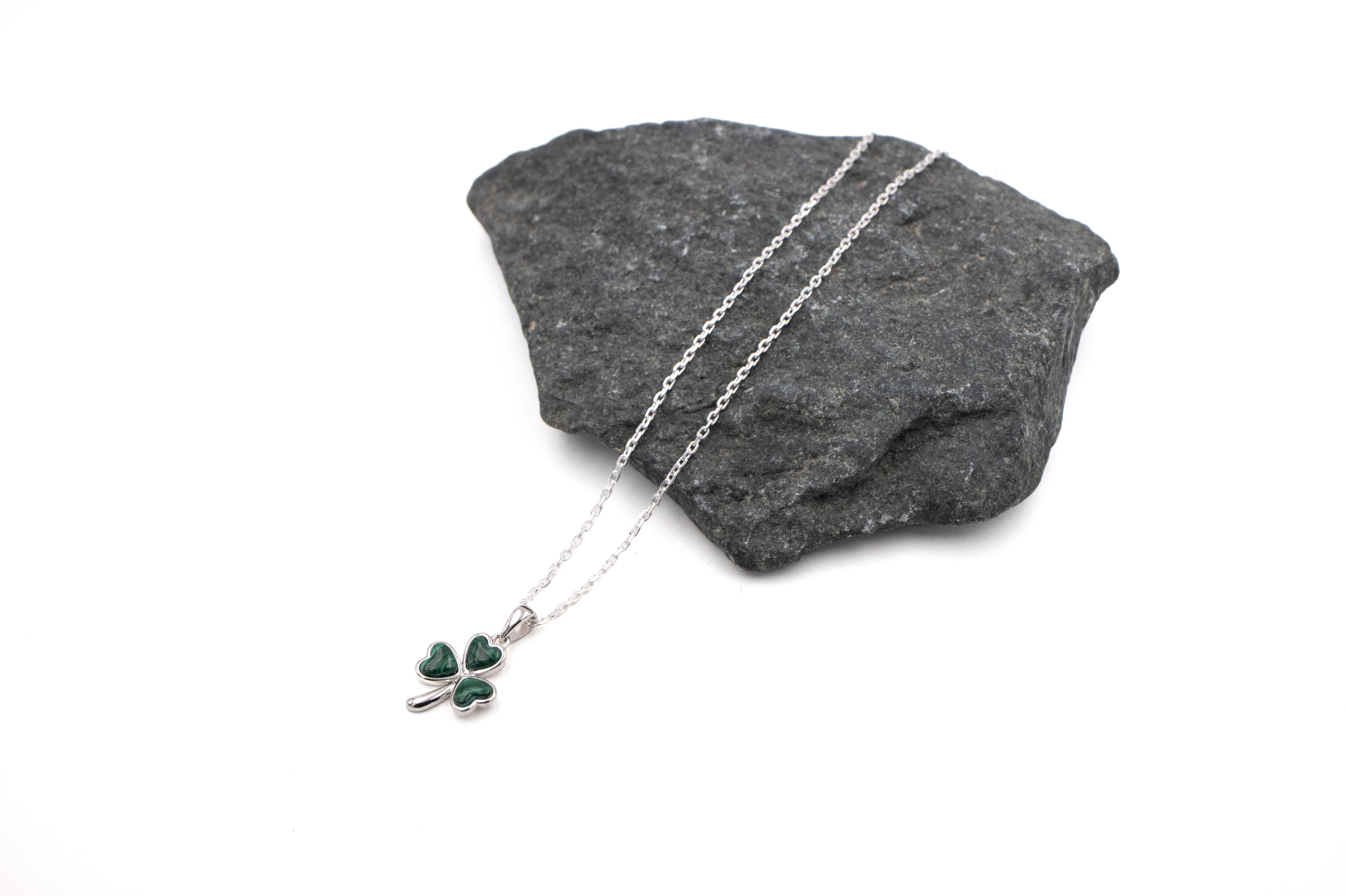 Womens Shamrock Necklace in Sterling Silver With a Polished Finish. Pictured Flat.