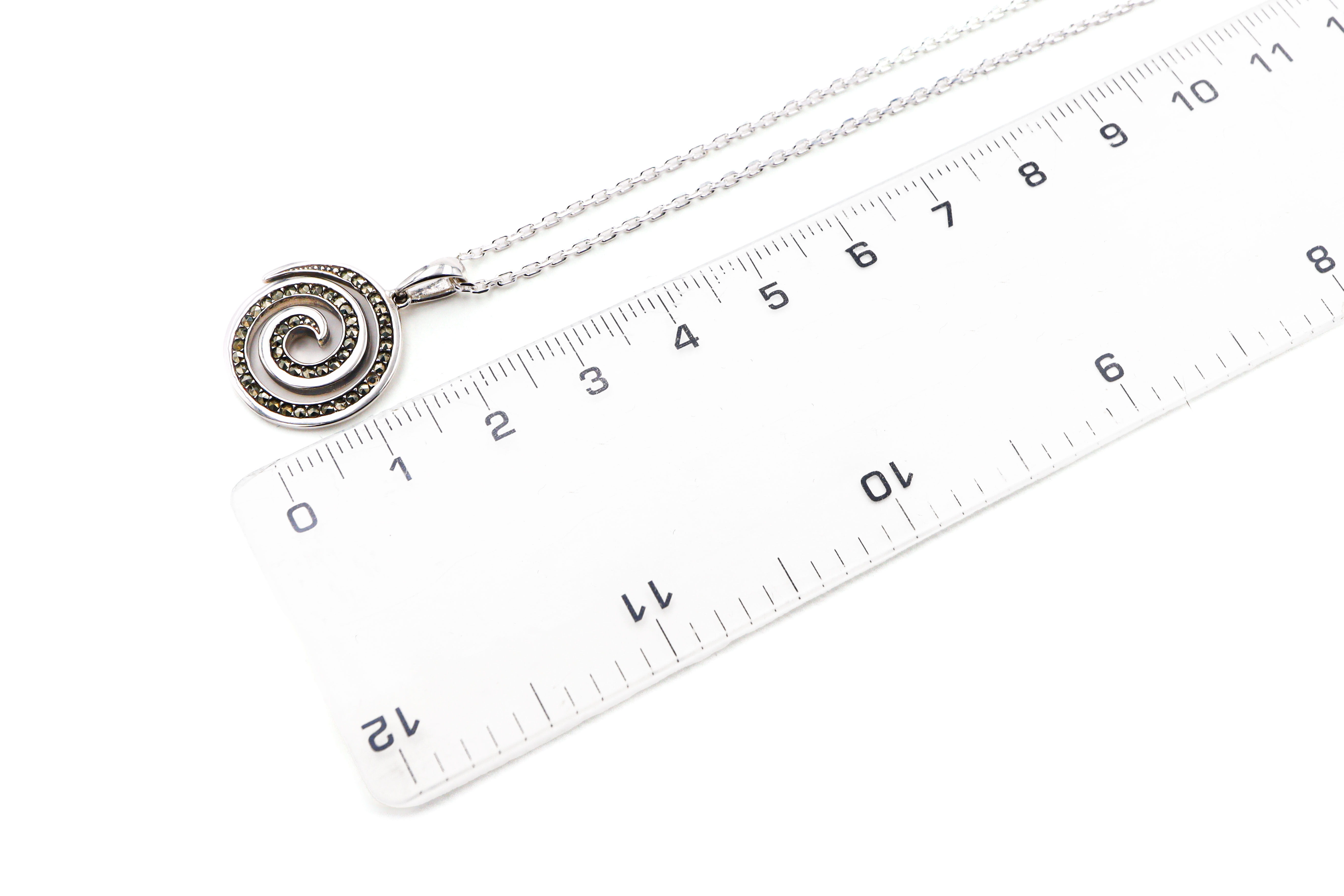 Womens Triskele Necklace in Sterling Silver. Picture For Scale.