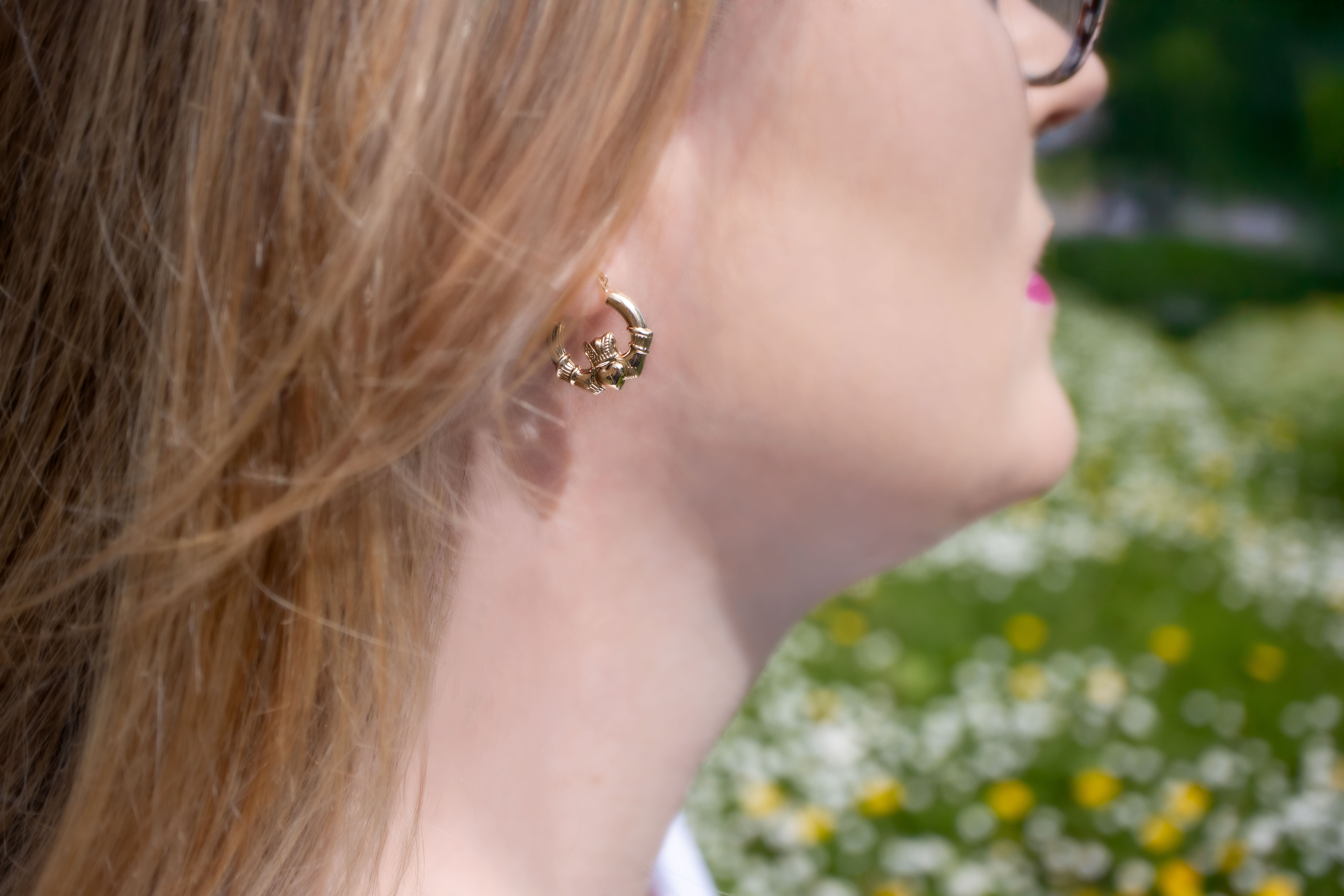 Medium Sized Striking Yellow Gold Claddagh Earrings For Women - Model Photo