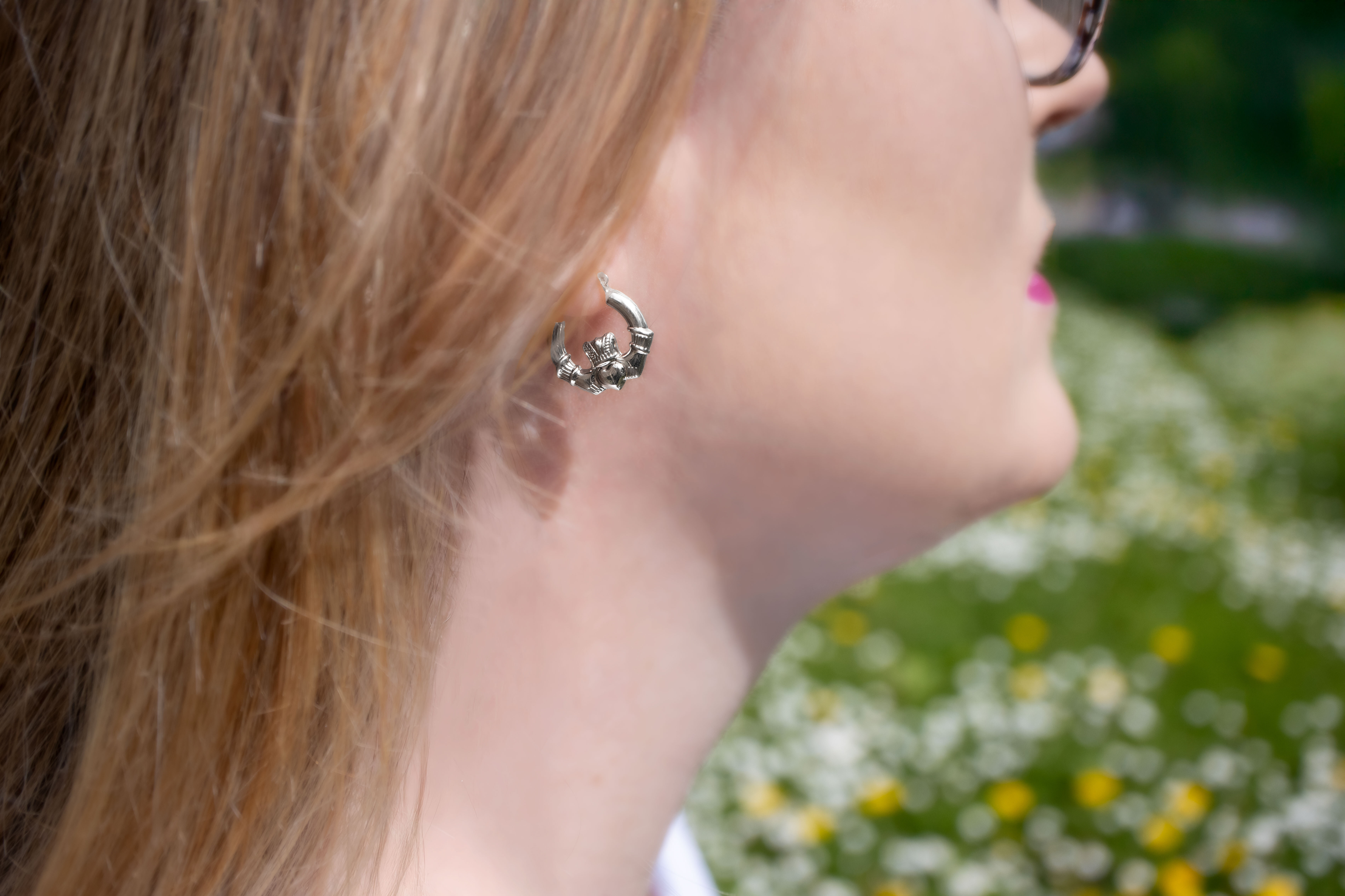 Womens Medium Sized Polished Sterling Silver Claddagh Earrings - Model Photo