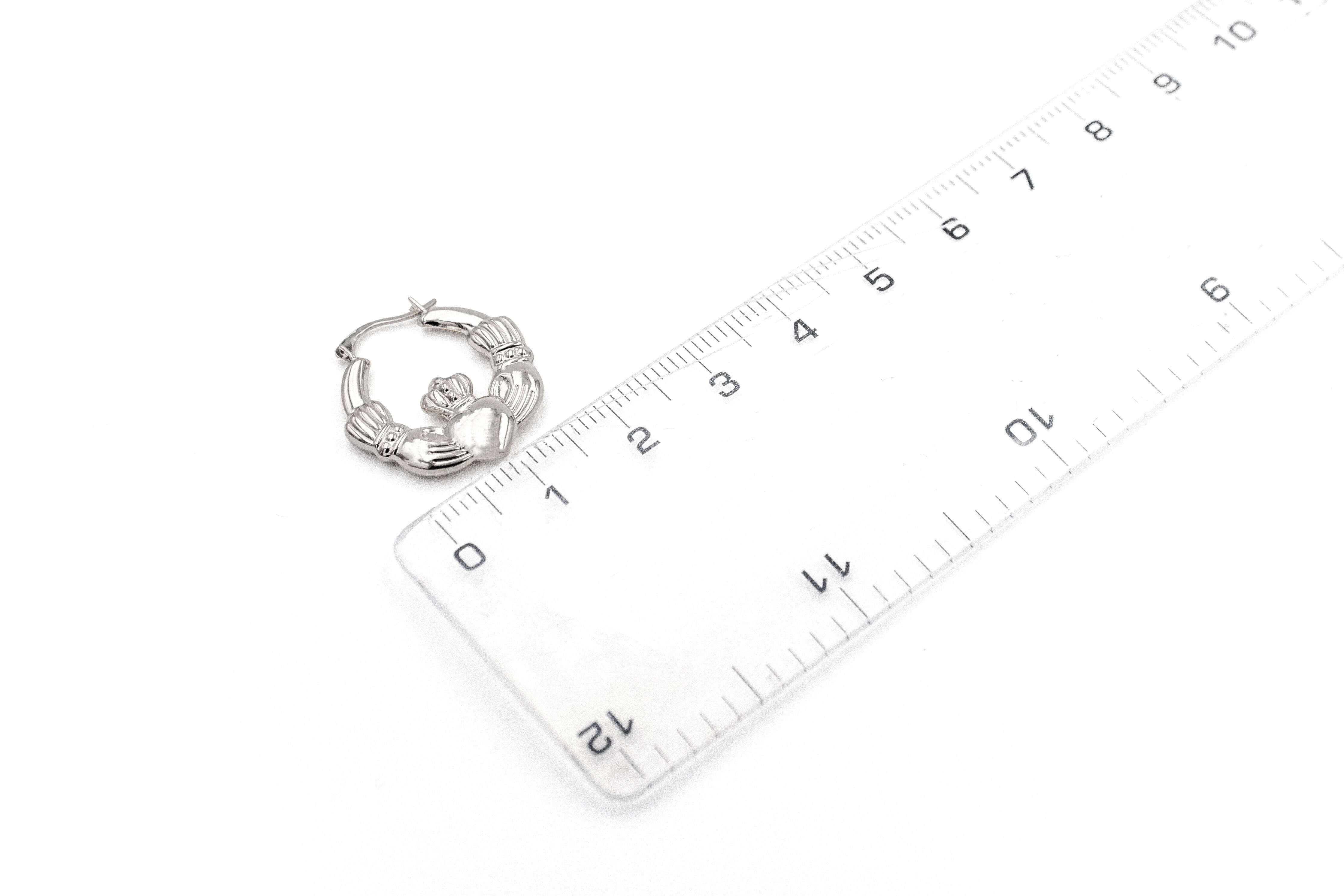 Womens Medium Sized Polished Sterling Silver Claddagh Earrings. Picture For Scale.