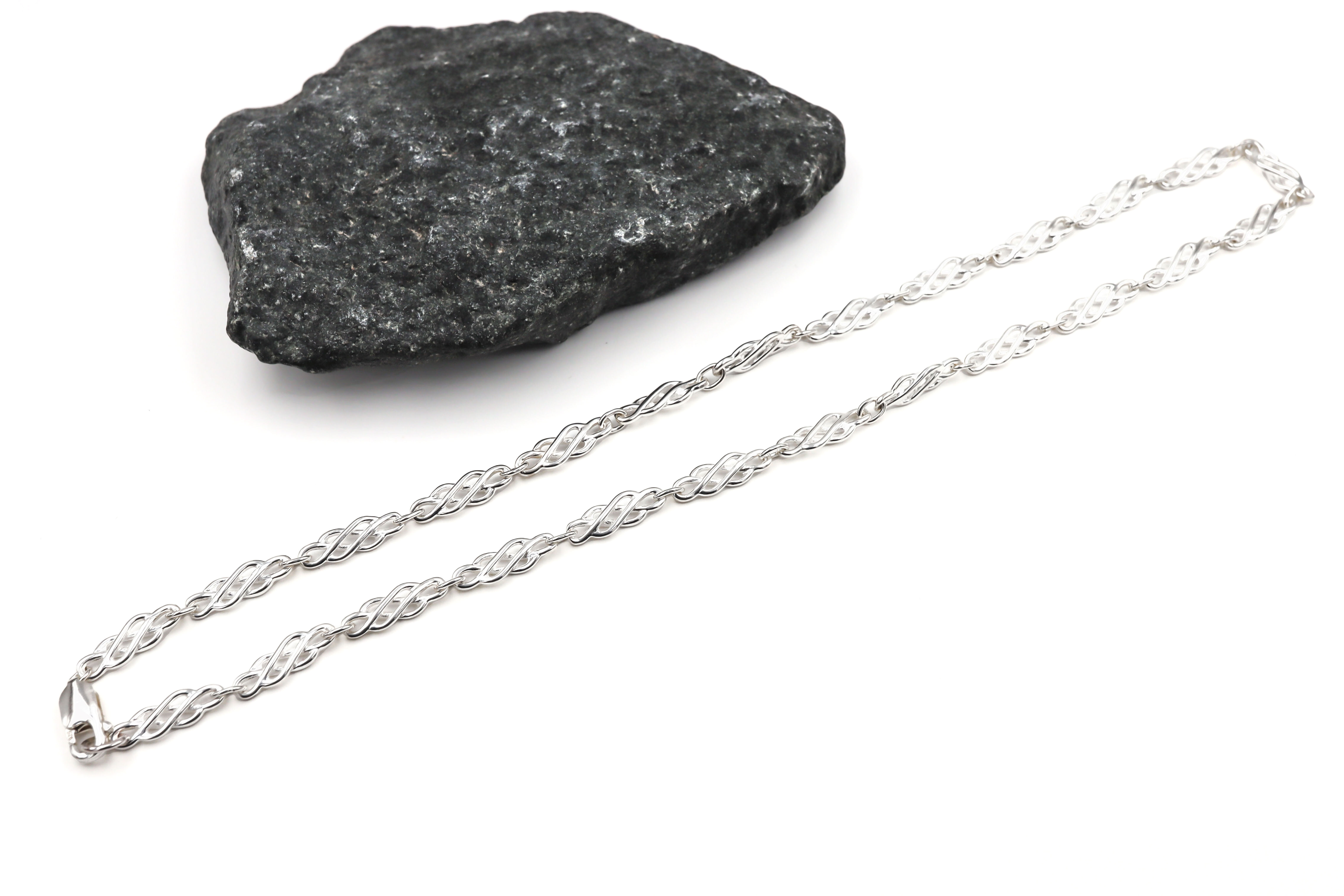 Womens Celtic Knot Necklace in Sterling Silver With a Polished Finish. Pictured Flat.