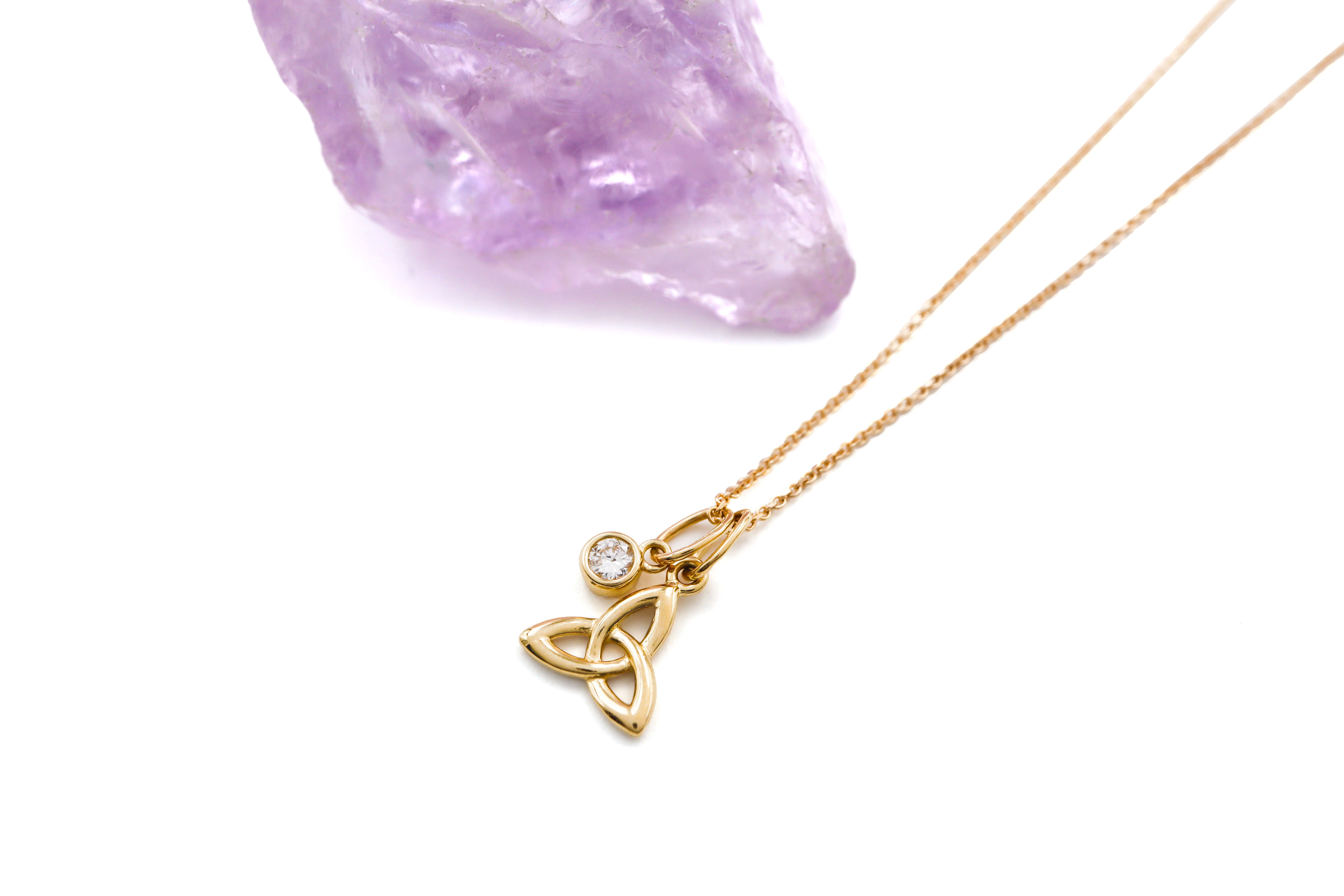 Attractive Yellow Gold Trinity Knot Necklace For Women With a Polished Finish. Pictured Flat.