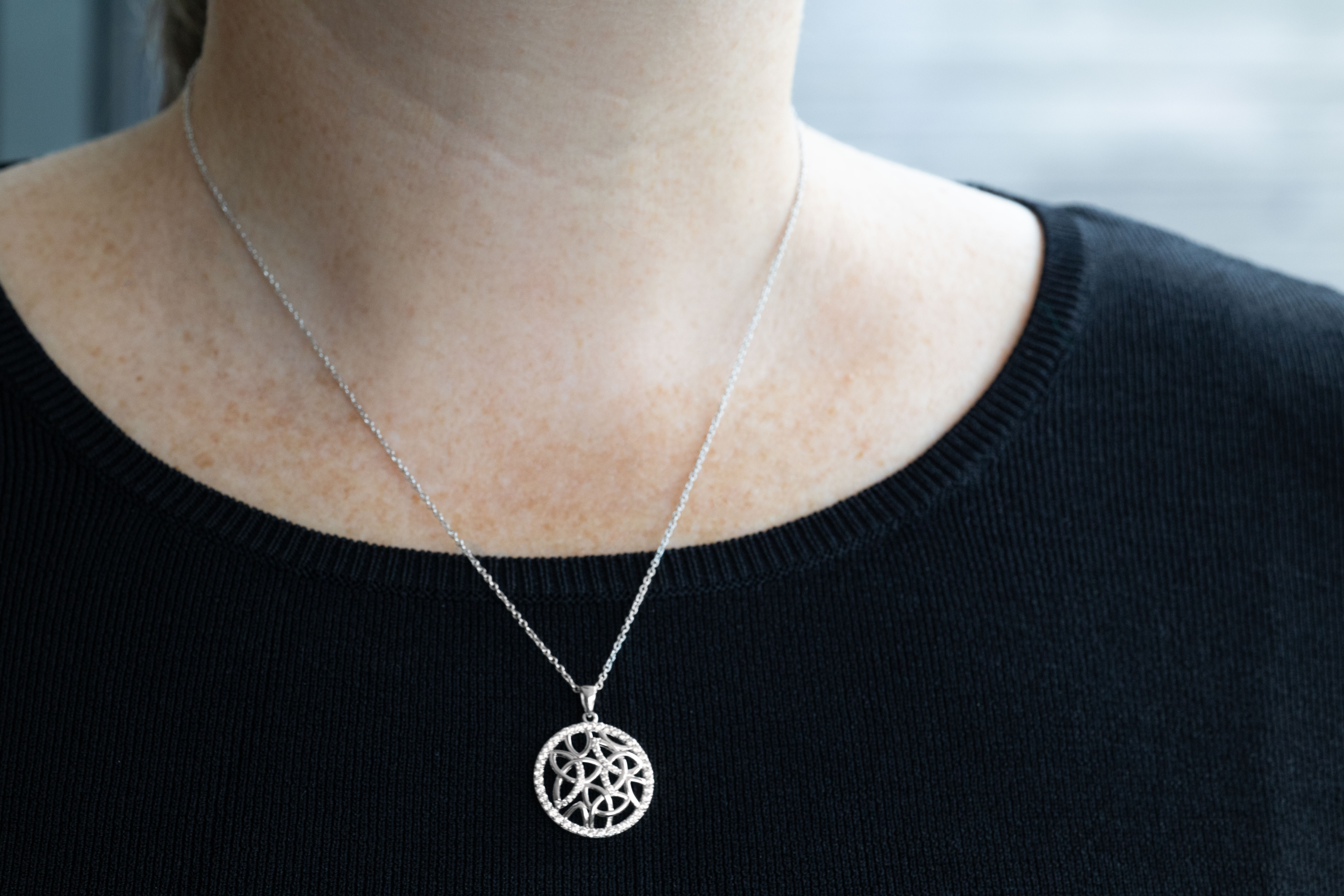 Attractive Sterling Silver Trinity Knot Necklace For Women With a Polished Finish - Model Photo