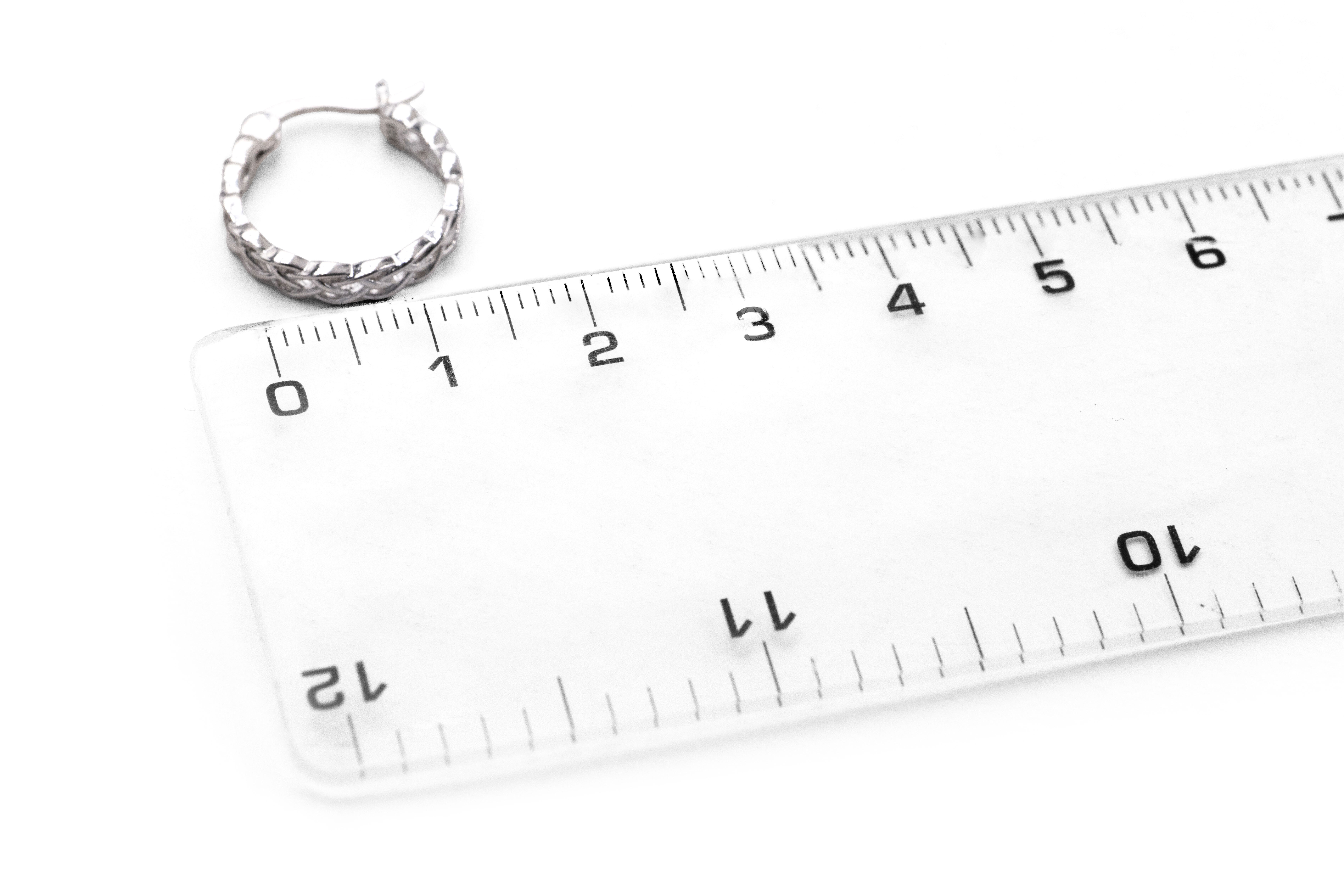 Striking Sterling Silver Celtic Knot Earrings For Women With a Polished Finish. Picture For Scale.