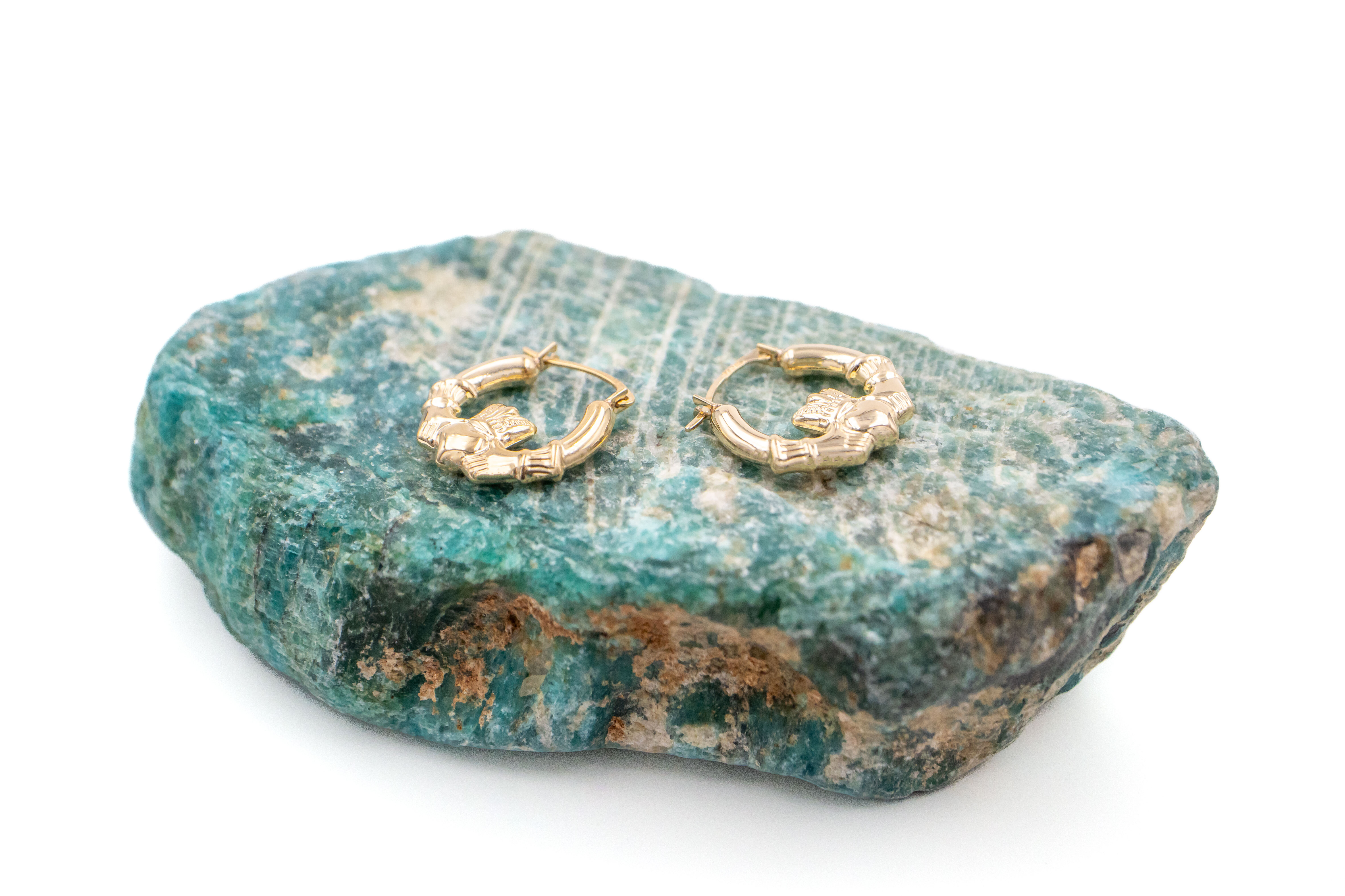 Small Real Yellow Gold Claddagh Earrings For Women With a Polished Finish. Pictured Flat.