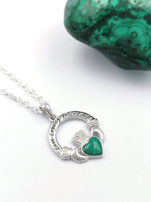 Womens Irish Sterling Silver Claddagh Necklace. Pictured Flat.