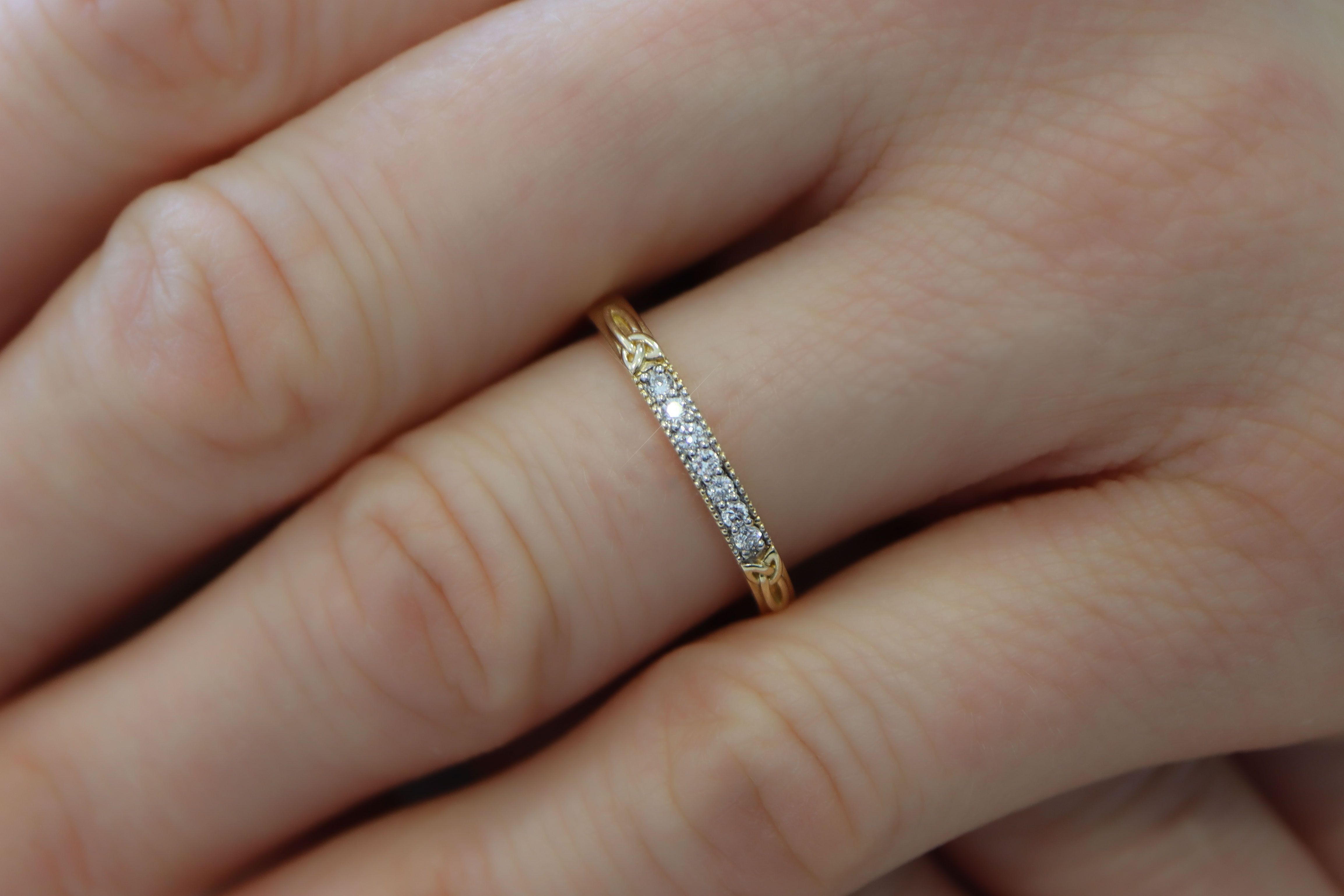 Womens Trinity Knot Wedding Ring in Yellow Gold With a Polished Finish - Model Photo
